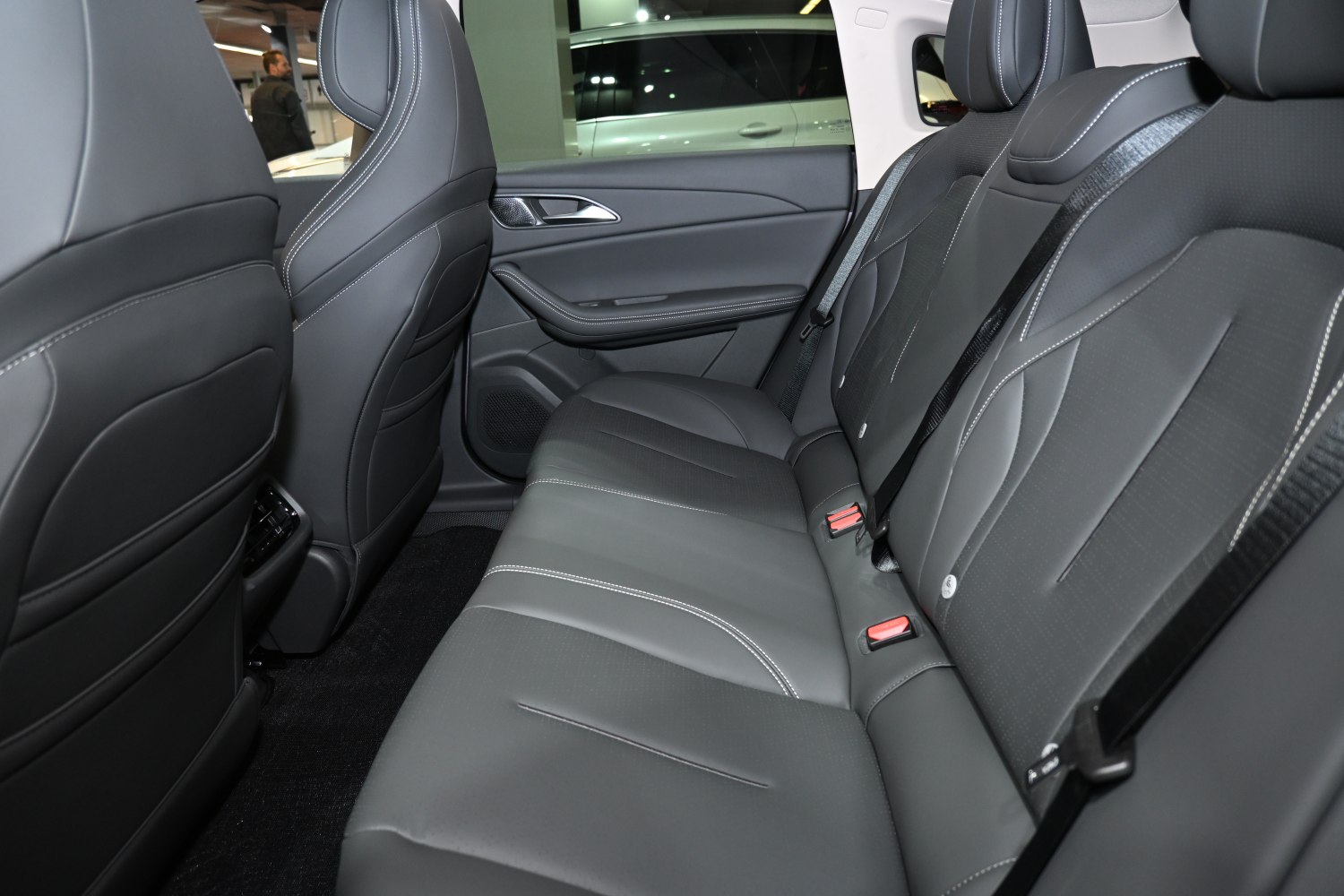 Rear seat with premium black leather upholstery and modern design.
