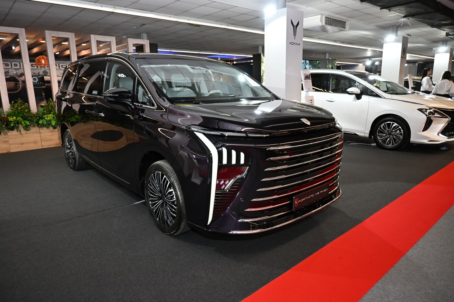 Bold front grille with integrated LED headlights on a sleek modern minivan.