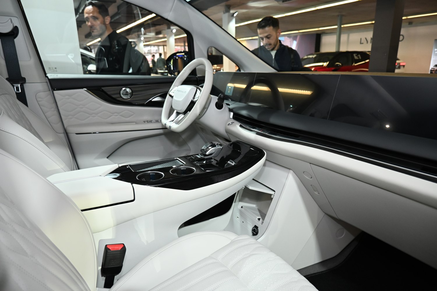Luxurious car interior with digital dashboard and white quilted seats