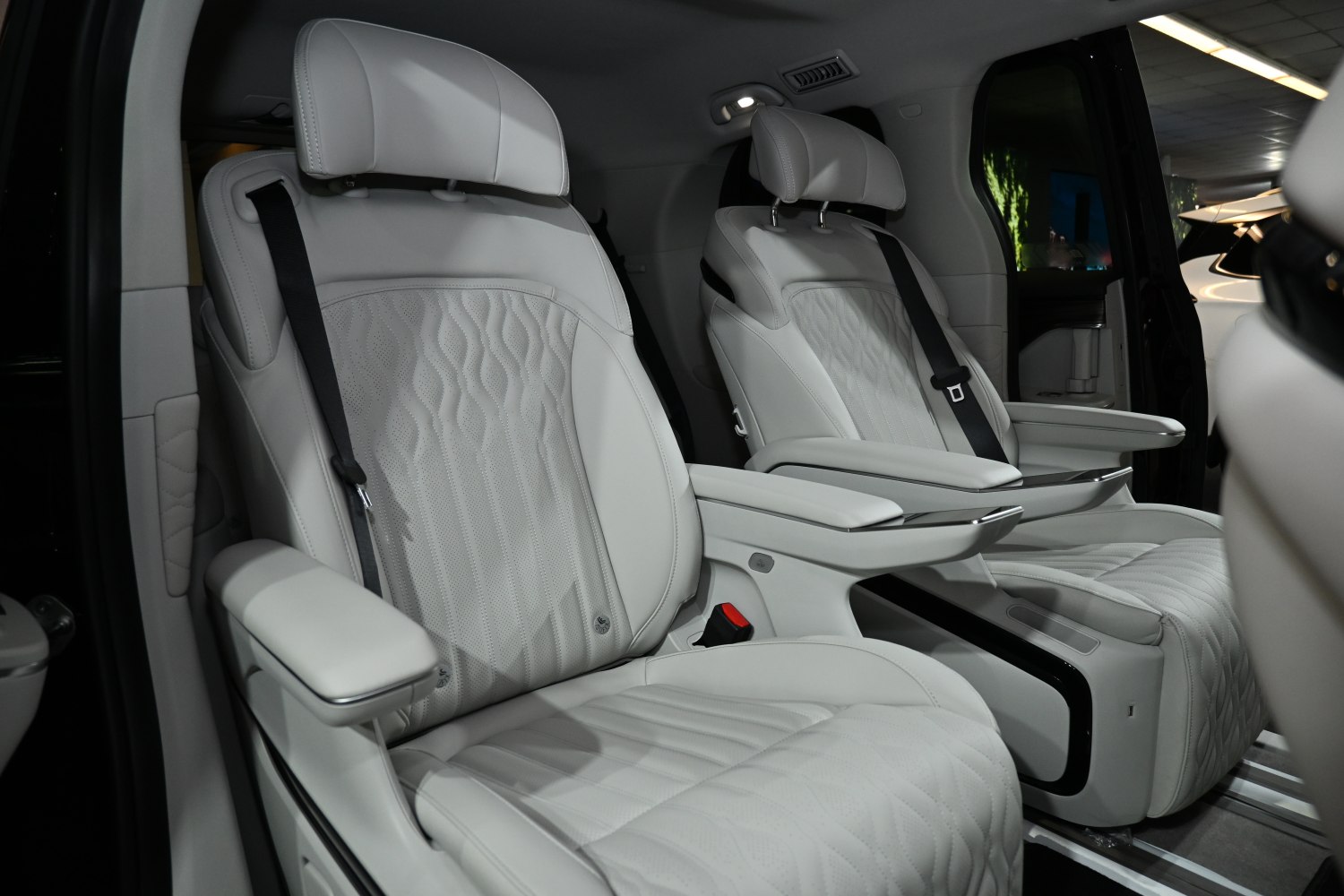 Premium white leather seats with armrests and detailed stitching