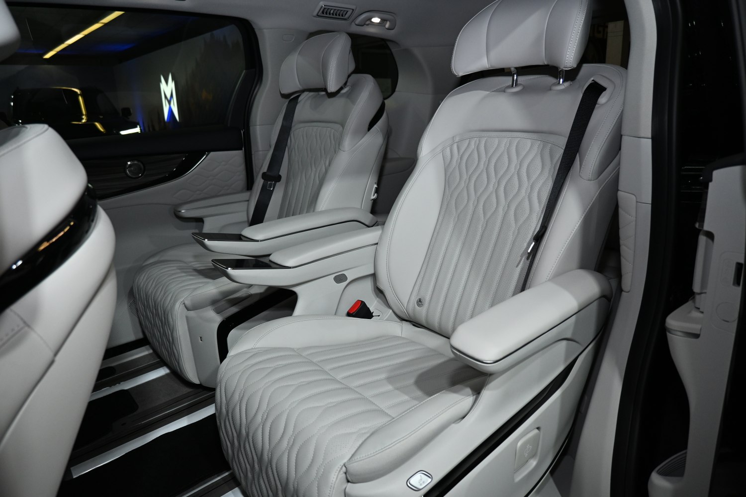 Quilted leather captain seats with armrests and seatbelts