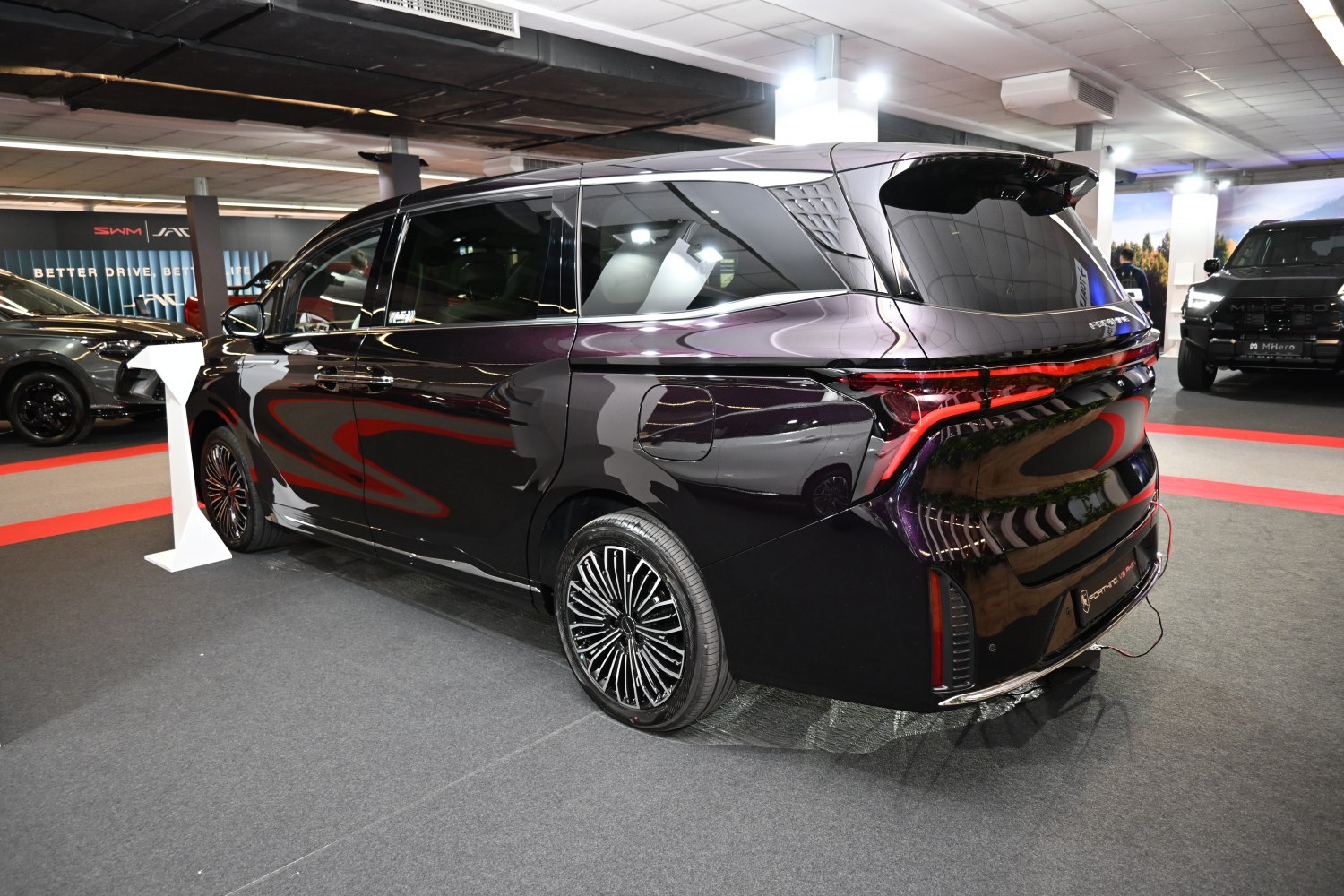 Luxury minivan rear with LED taillights and multi-spoke wheels