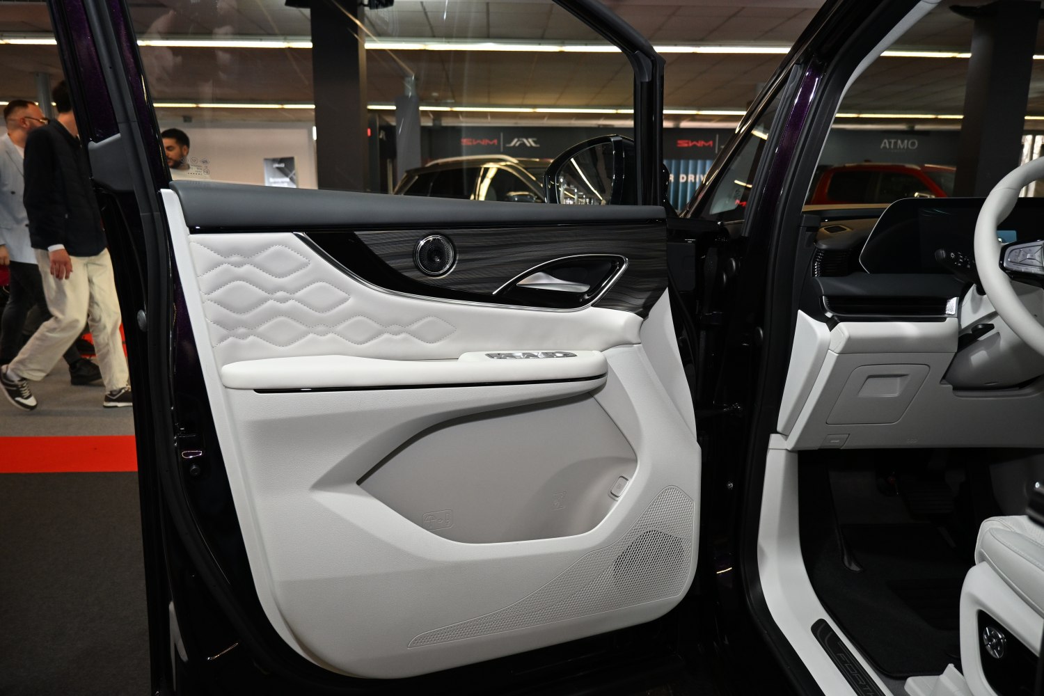 White quilted leather door panel with wood trim and control buttons