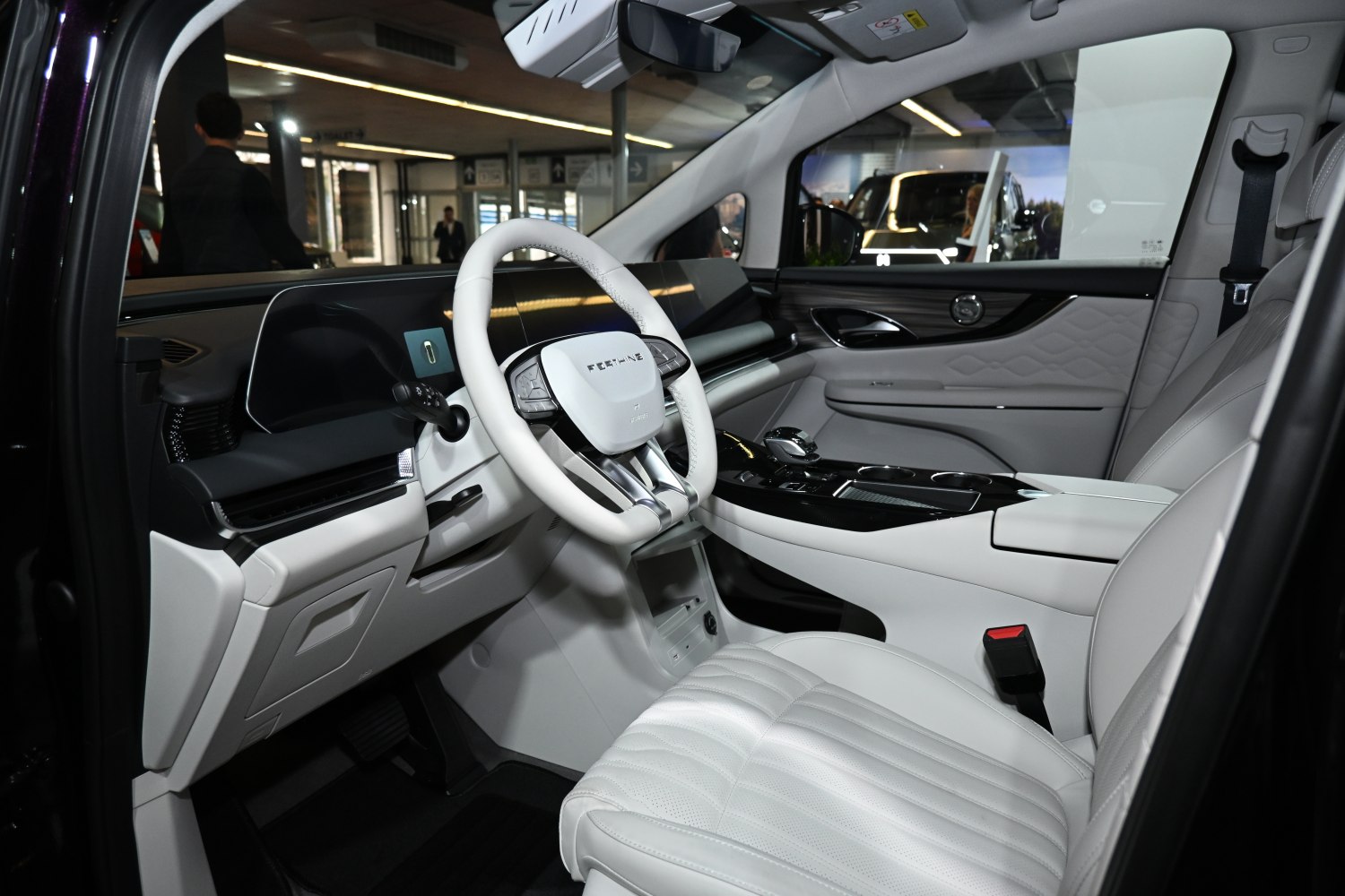 Modern car interior with digital dashboard and white leather seats
