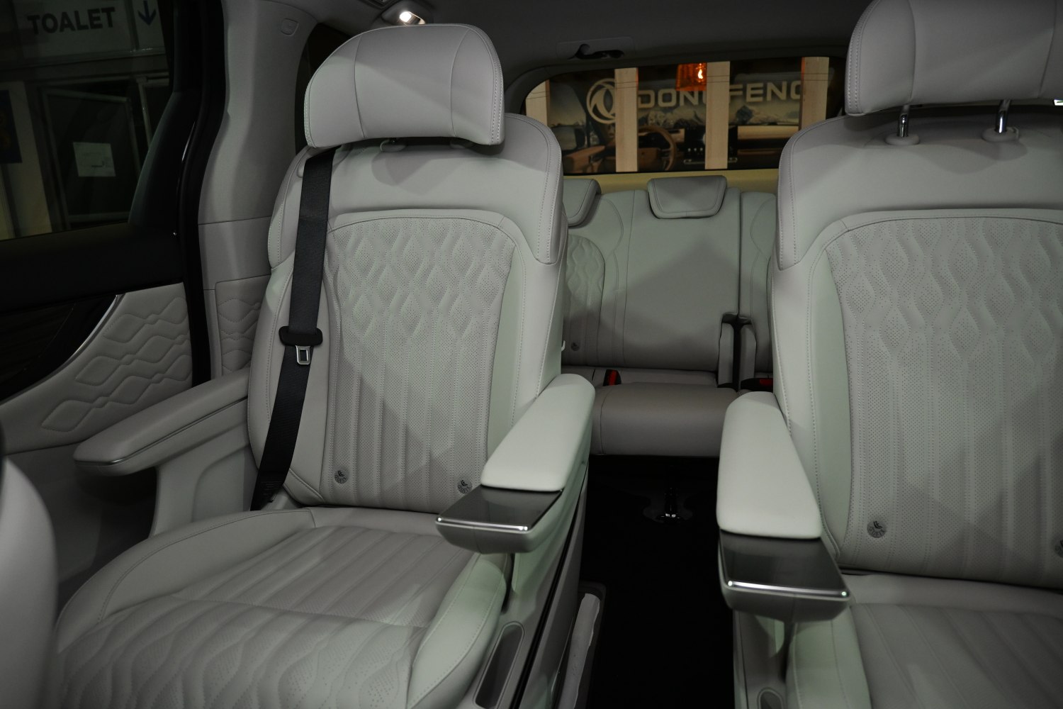 Beige leather seats with detailed stitching and armrests