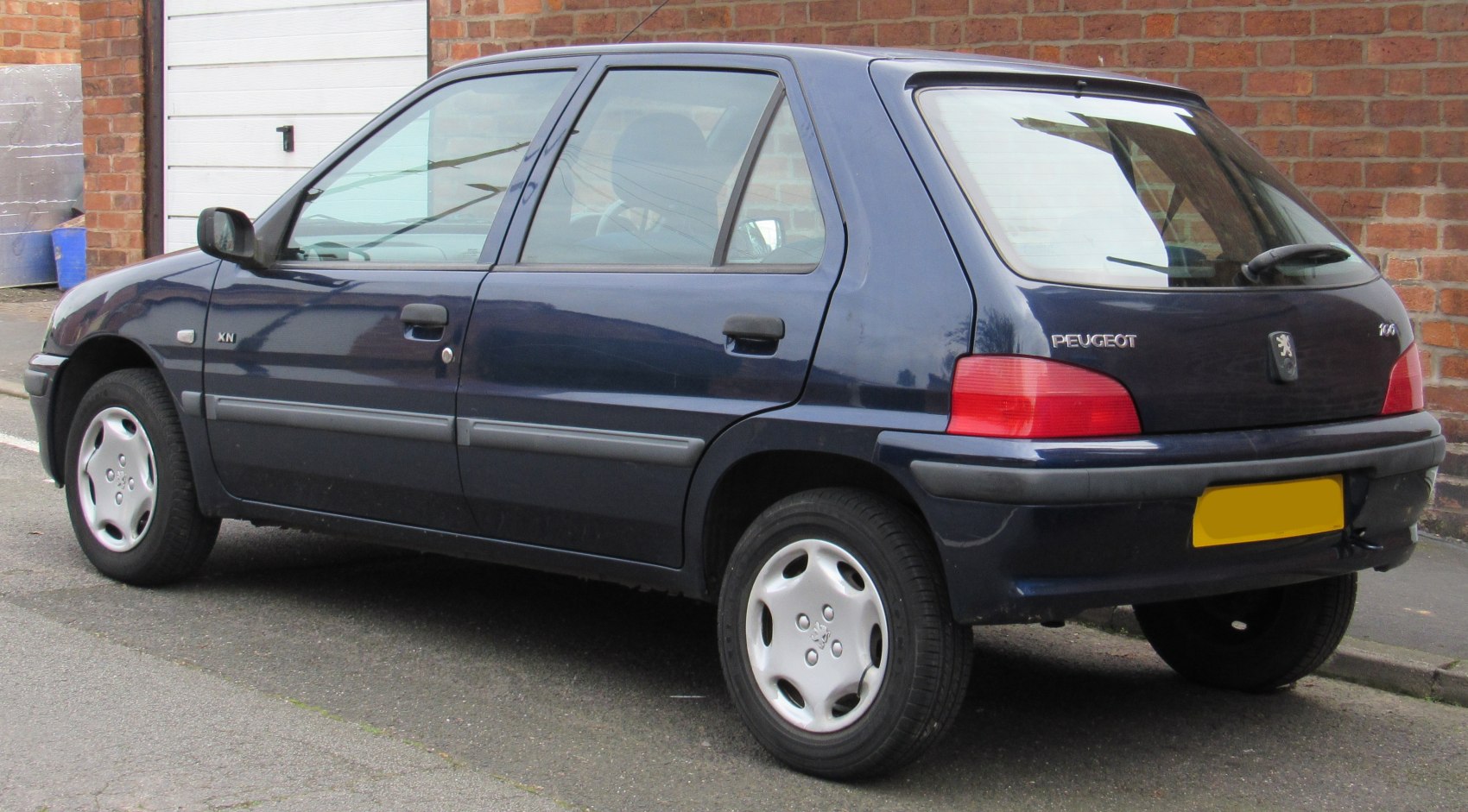 Rear side profile of a compact hatchback with distinctive tail lights