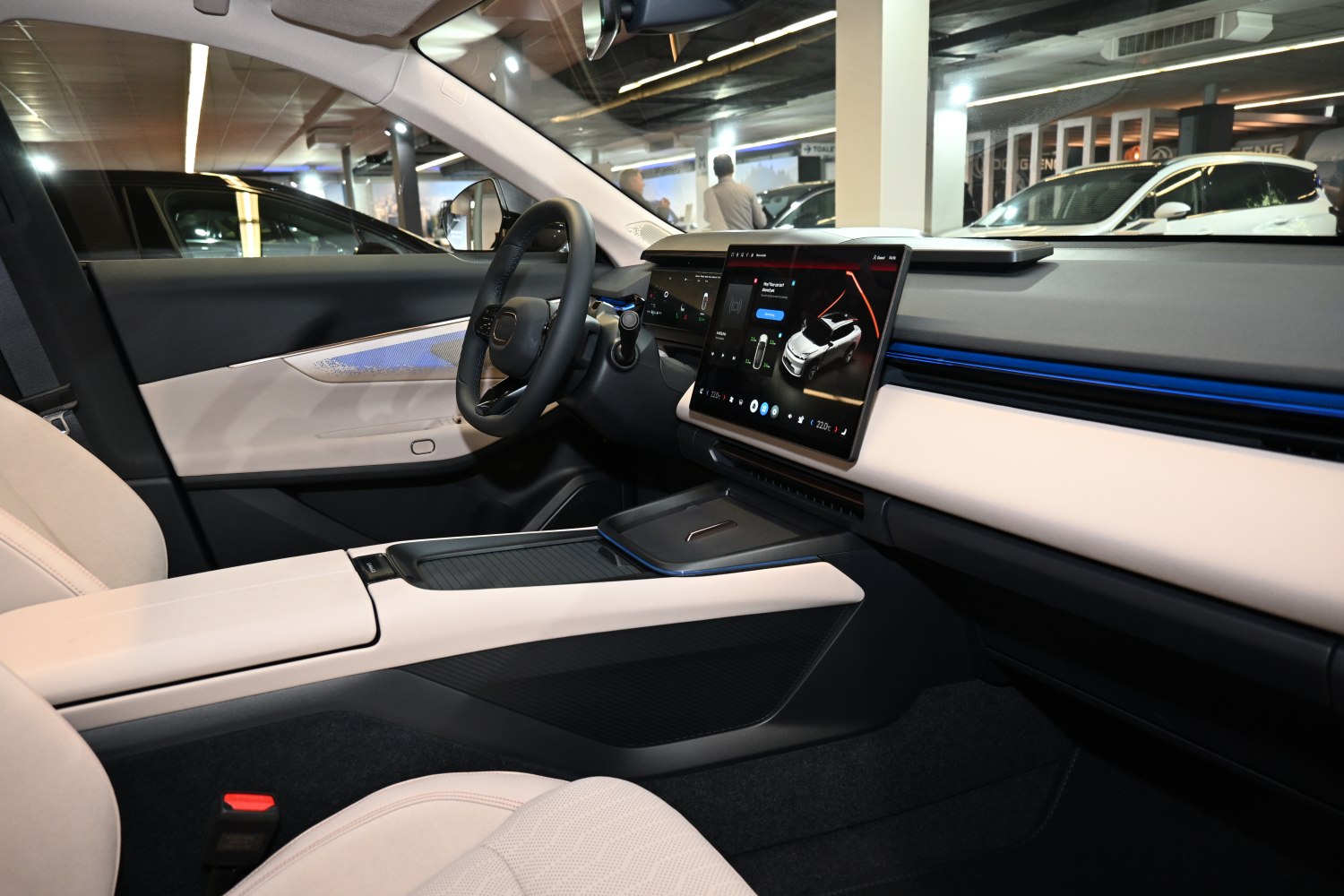 Minimalist car interior with central touchscreen and ambient lighting