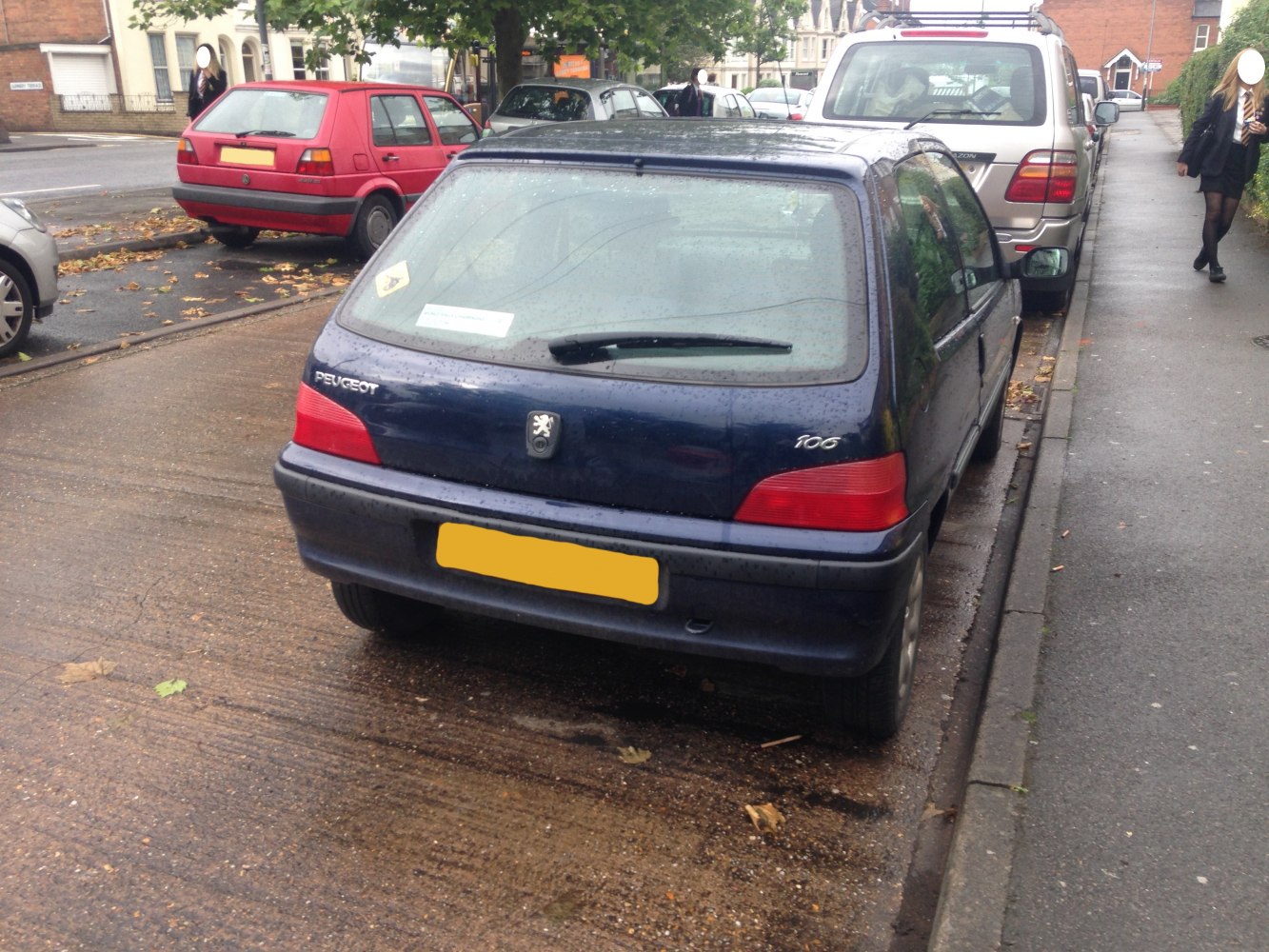 Compact hatchback rear with taillights, rear wiper, and badge