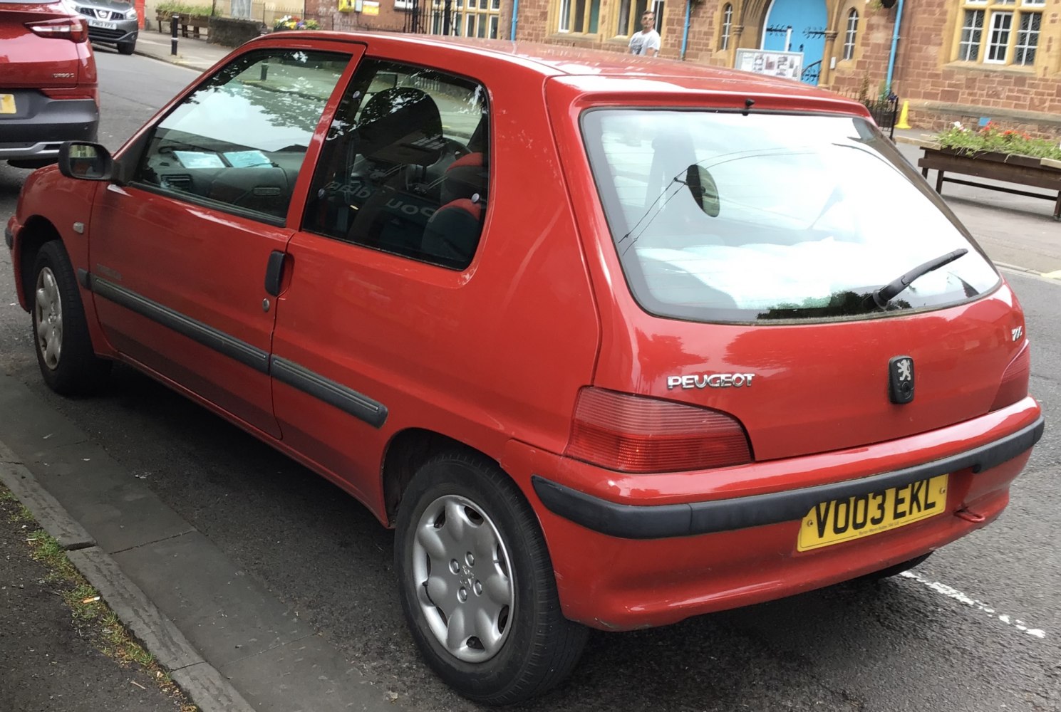 Red compact hatchback rear side view with alloy wheels
