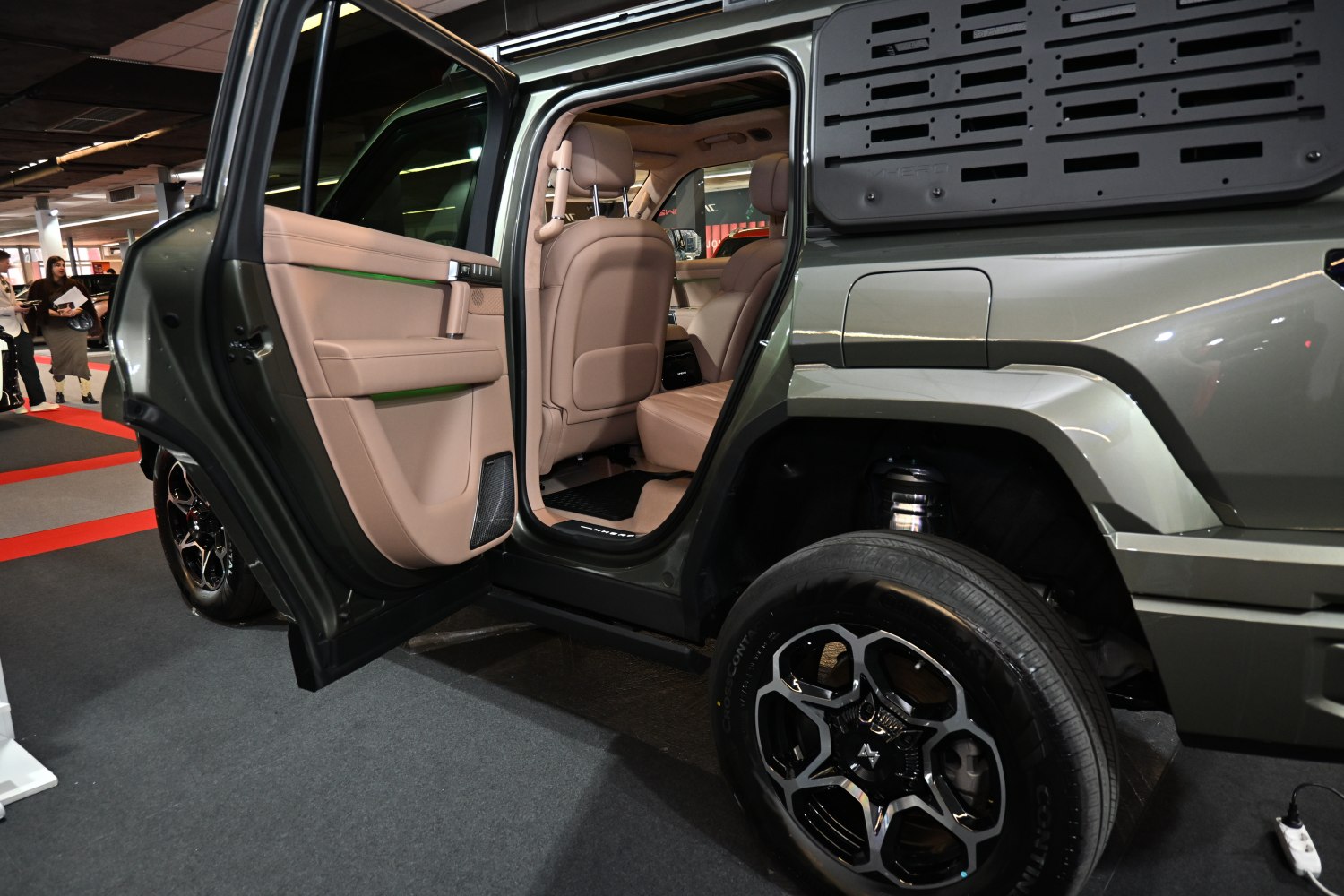 Rear door open, beige interior seats, unique wheel design