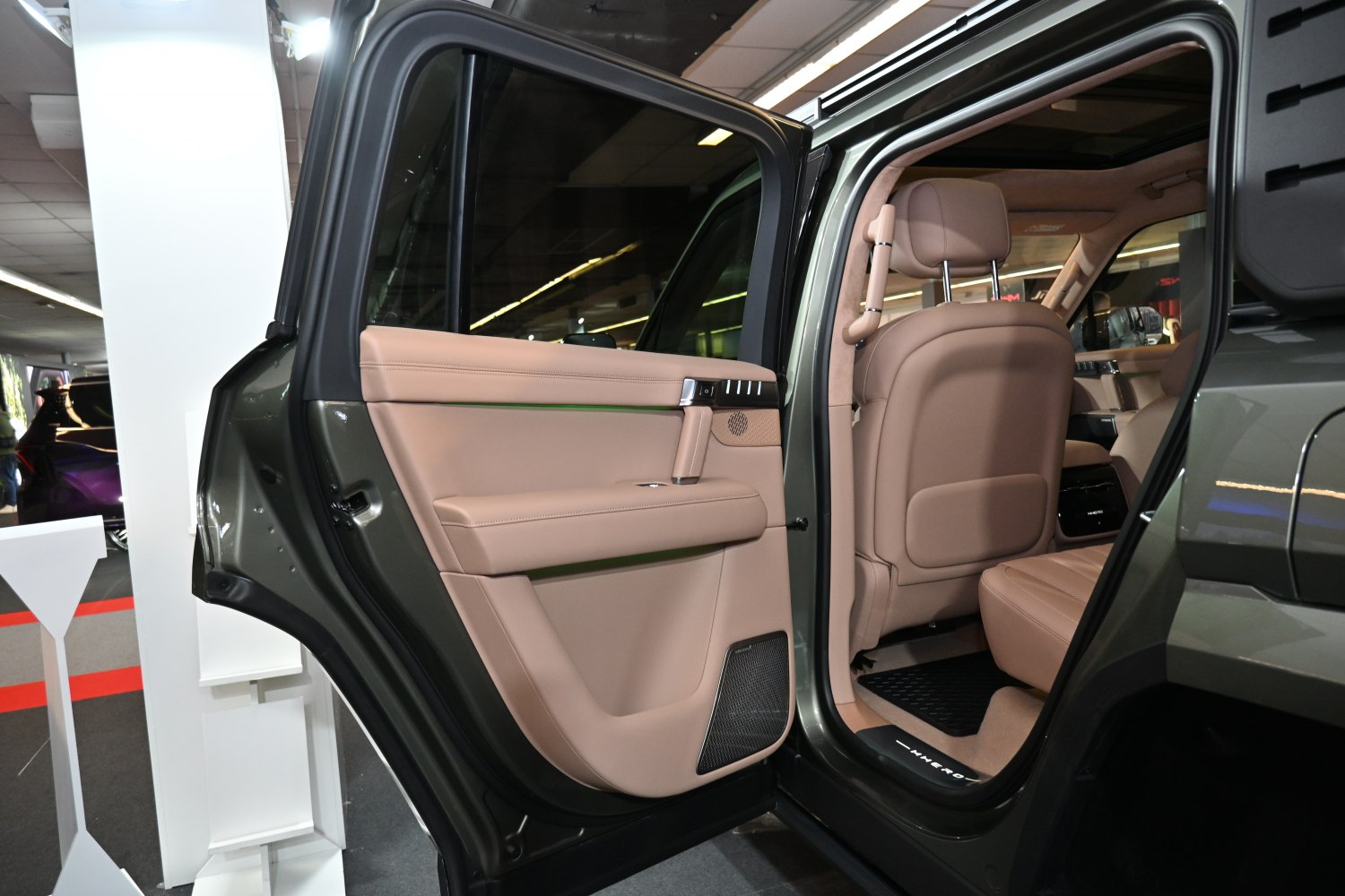 Luxury beige leather rear door with back seat interior.