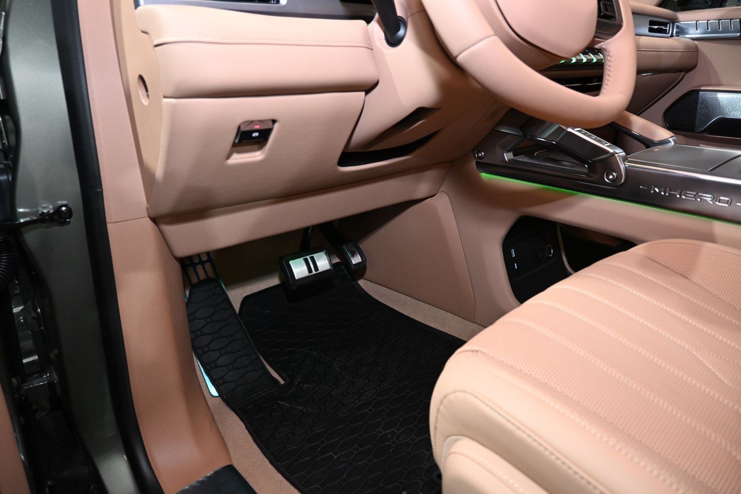 Beige leather seats and pedal area in a modern car interior