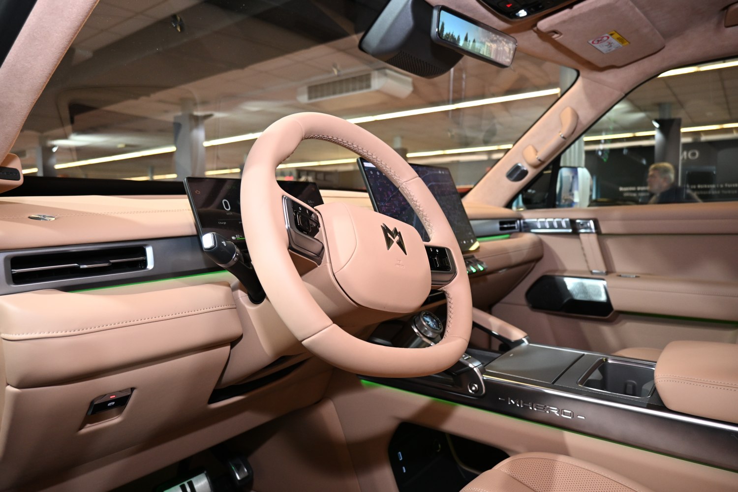 Luxury dashboard with digital instruments and leather steering wheel
