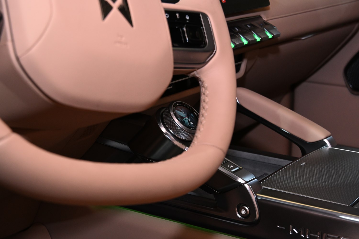 Beige leather steering wheel and control dial with illuminated buttons