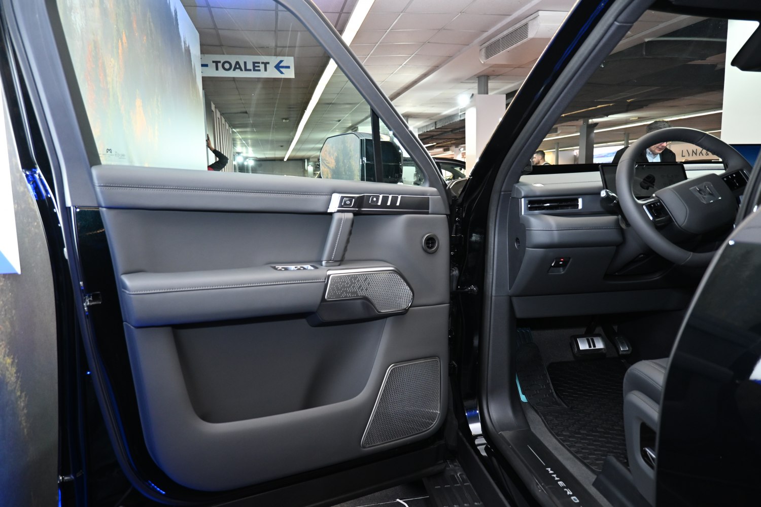 Driver-side door panel with controls and modern dashboard view