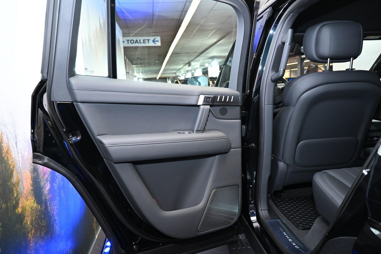 Rear interior door panel with premium materials and modern controls