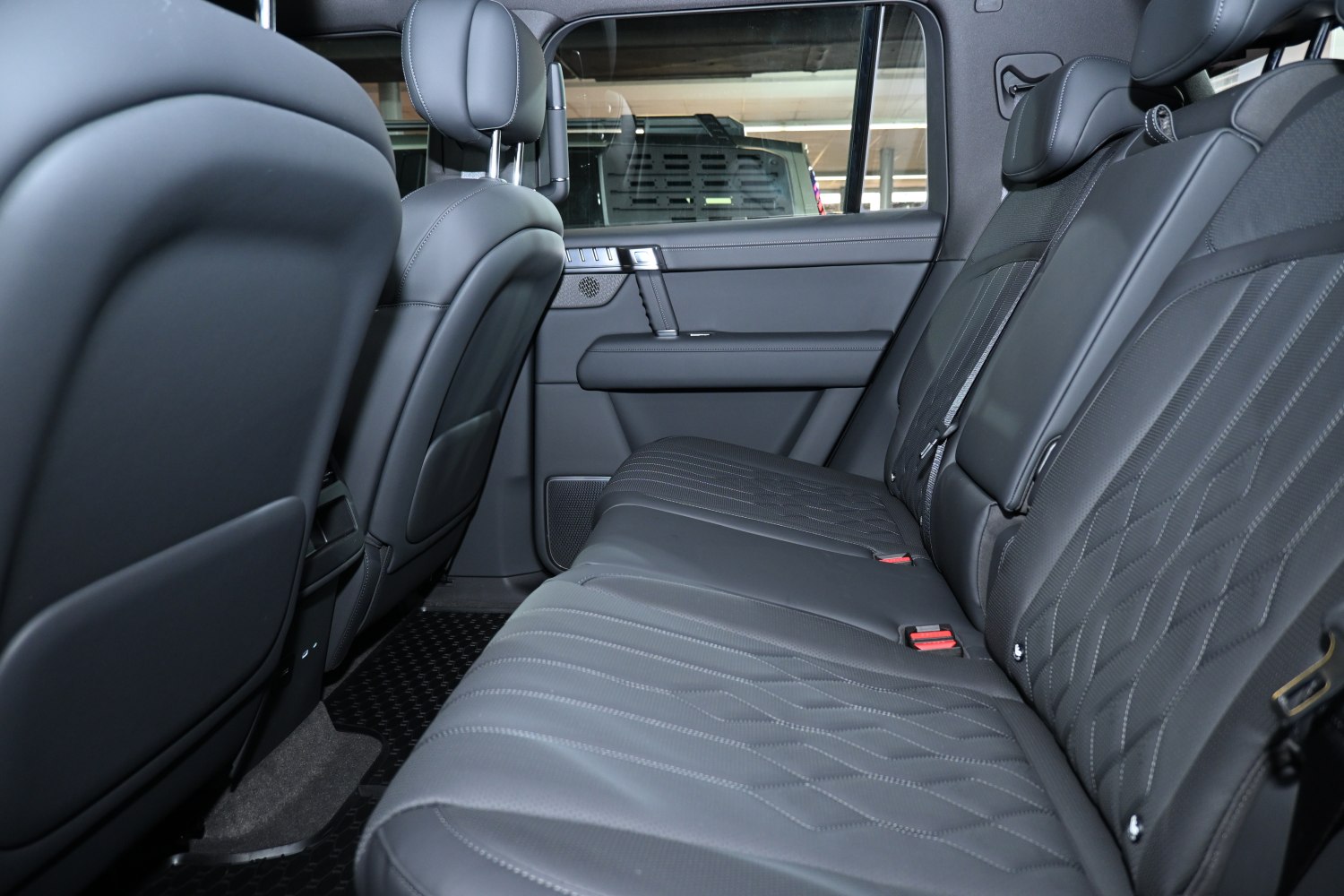 Spacious rear leather seats with modern car interior design features.