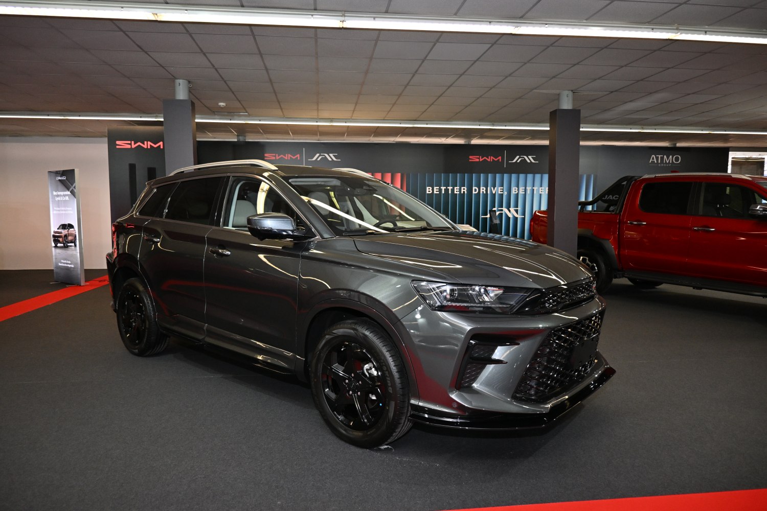 SUV front side view with black alloy wheels and aggressive grille