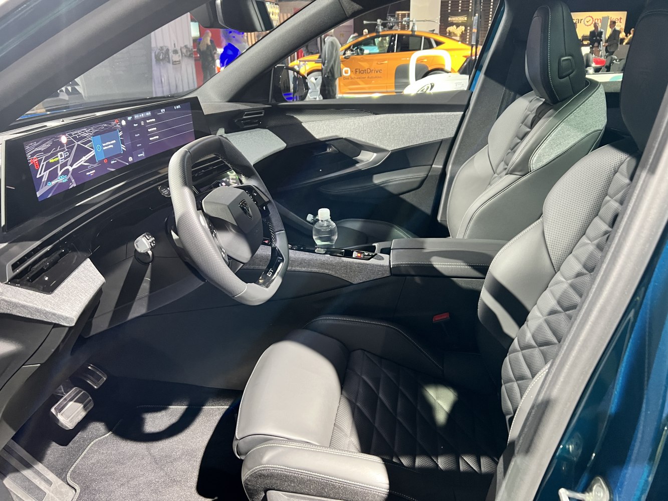 Digital instrument cluster and quilted leather seats in modern car interior