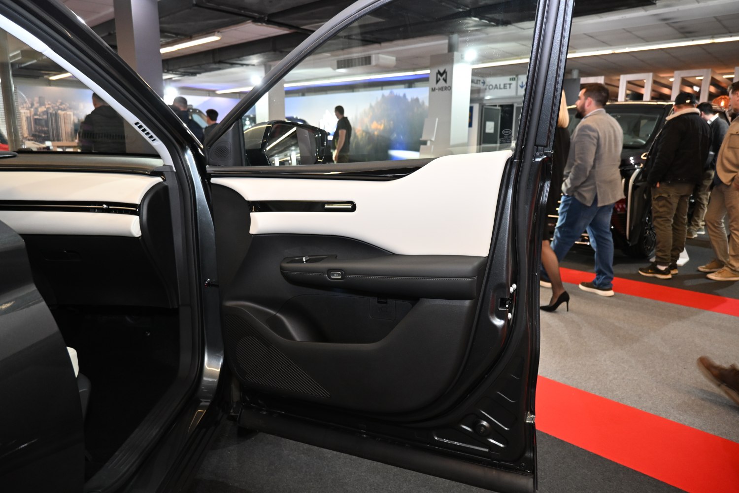 Interior door panel with black and white styling and window controls