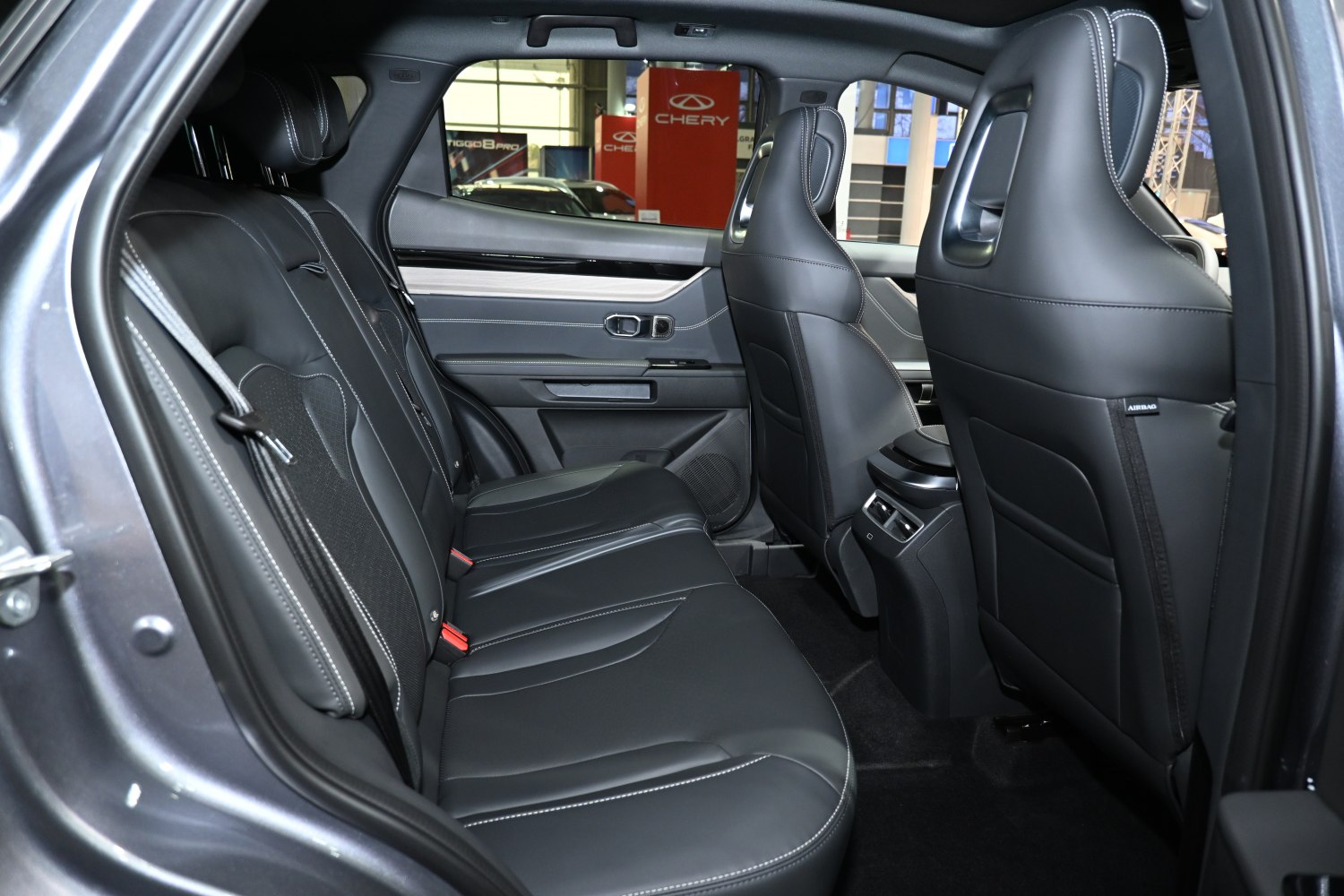 Leather rear seats with detailed stitching and rear cabin interior.