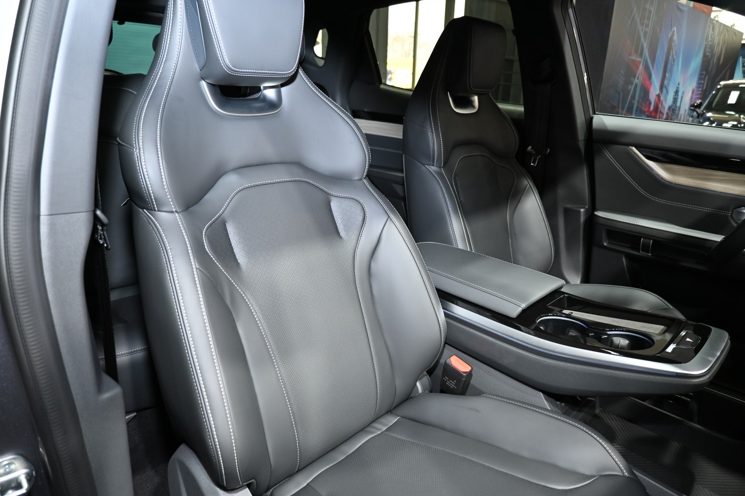 Black leather bucket seats with detailed stitching and a sleek center console