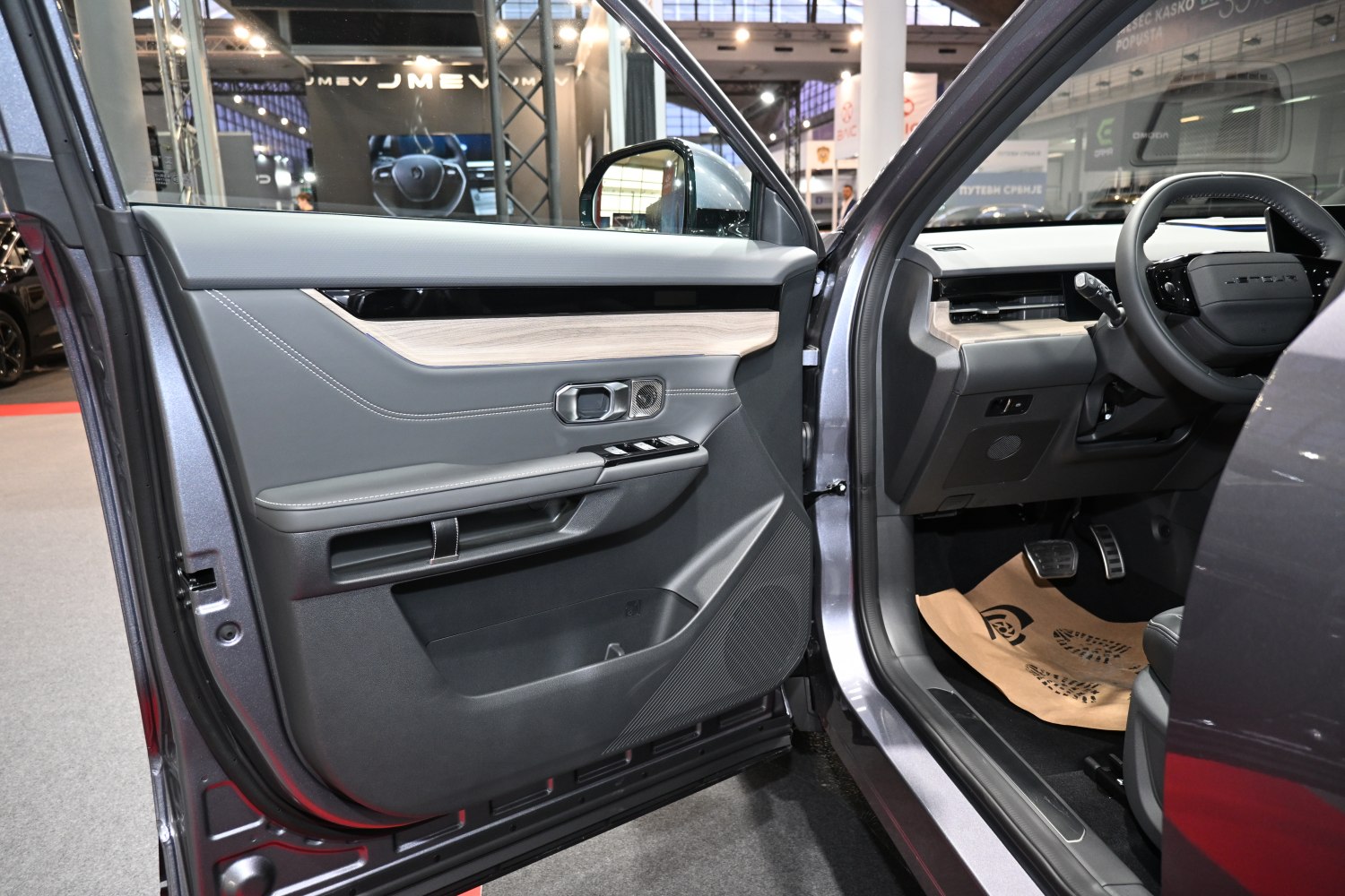 Driver side door panel and dashboard interior with controls and pedals