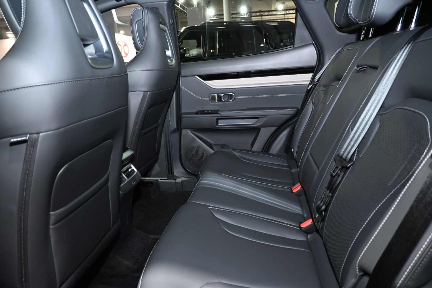 Rear seat interior with leather upholstery and modern design.