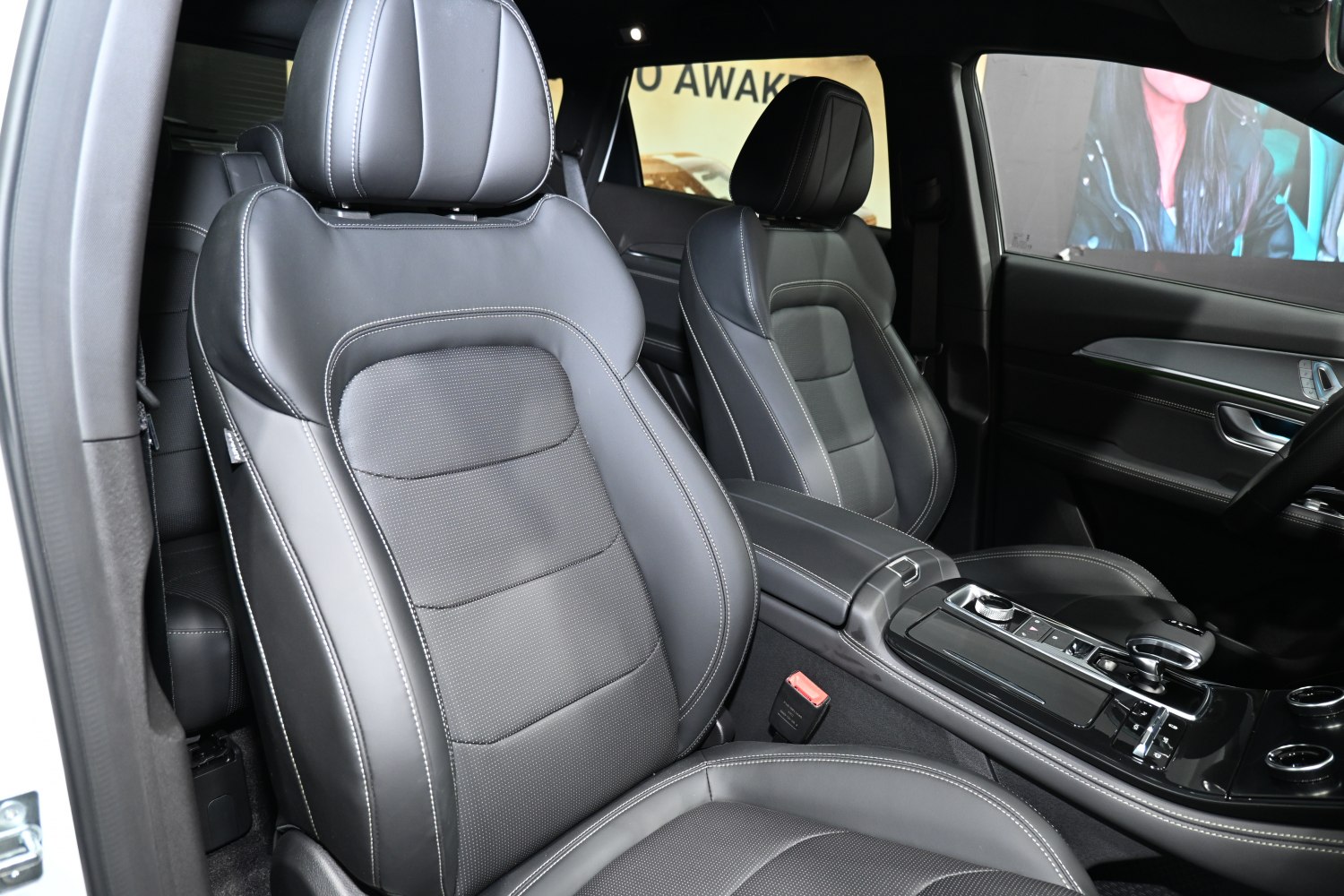 Luxury black leather front seats with center console and control panel.