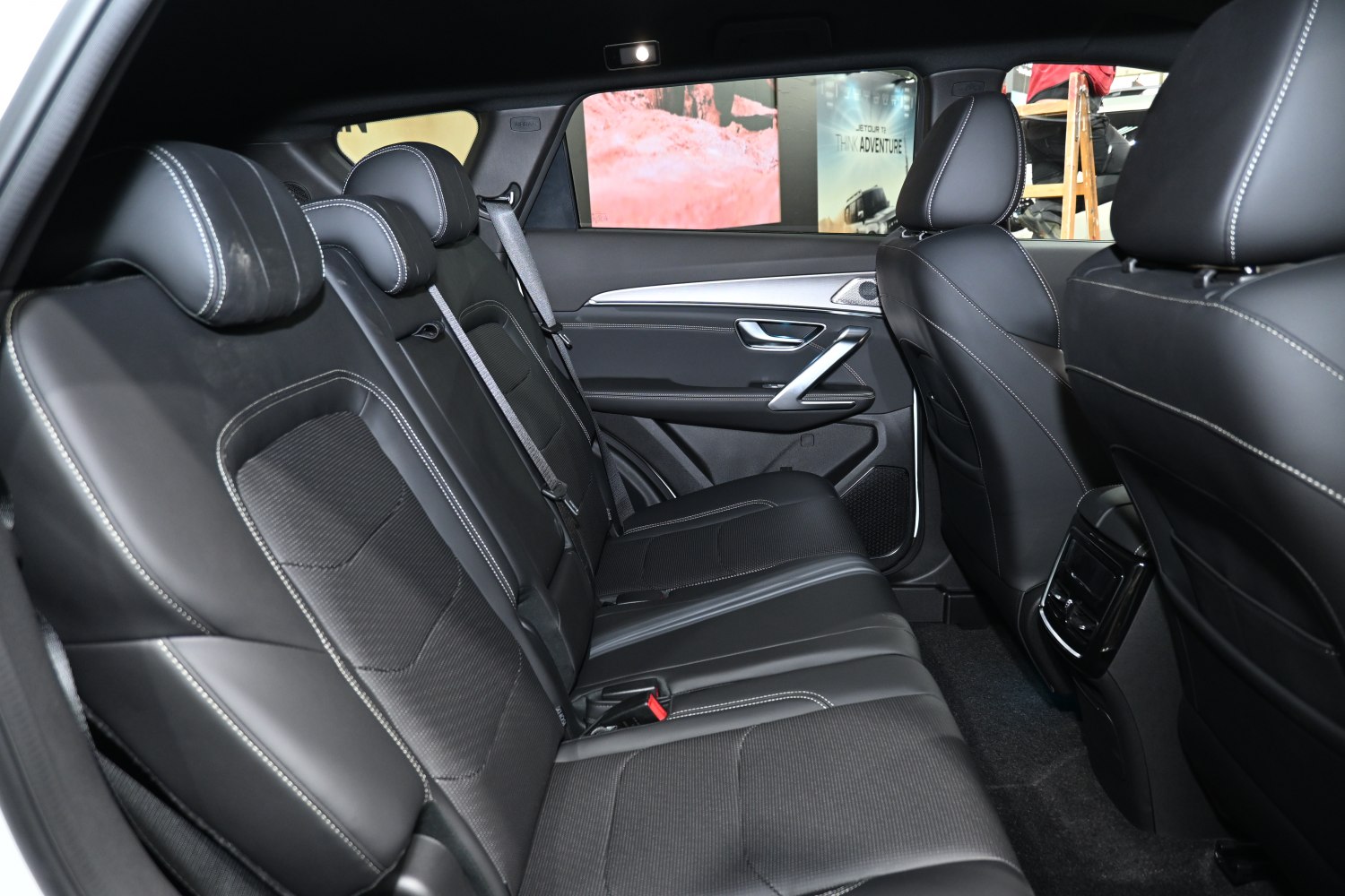 Black leather rear seats with stitching and spacious interior