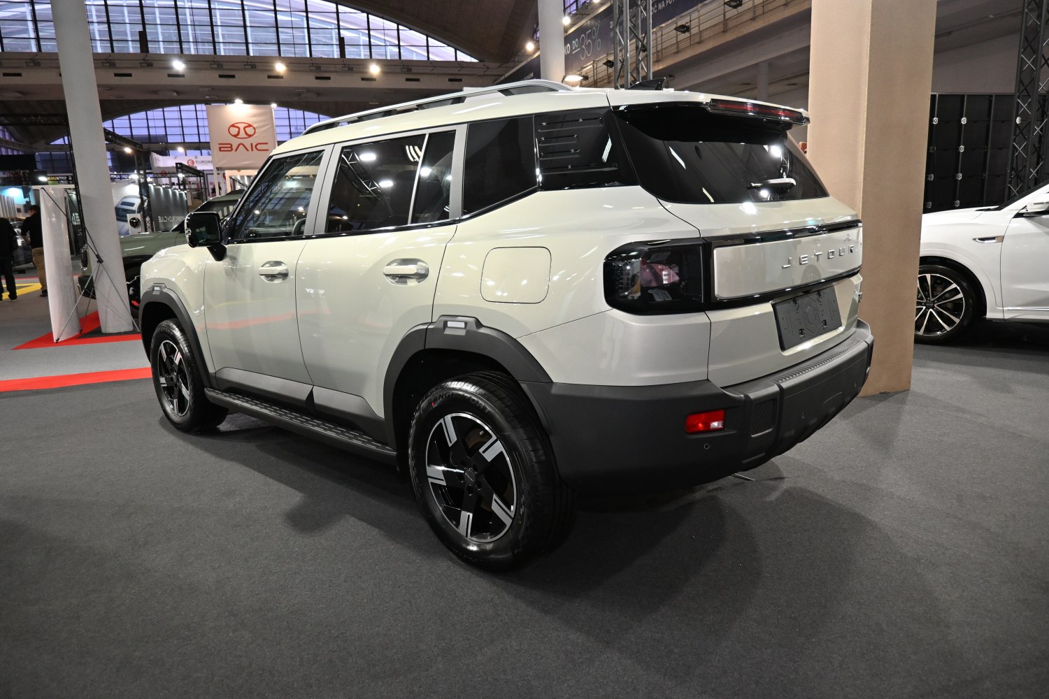 Rear side of white SUV with LED tail lights and bold wheels