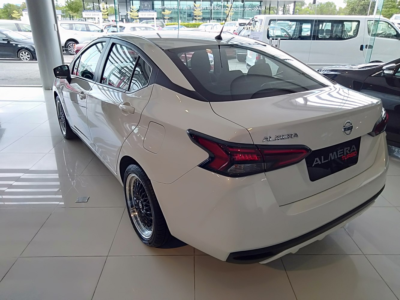 Rear and side view of white sedan with unique tail lights and sleek design