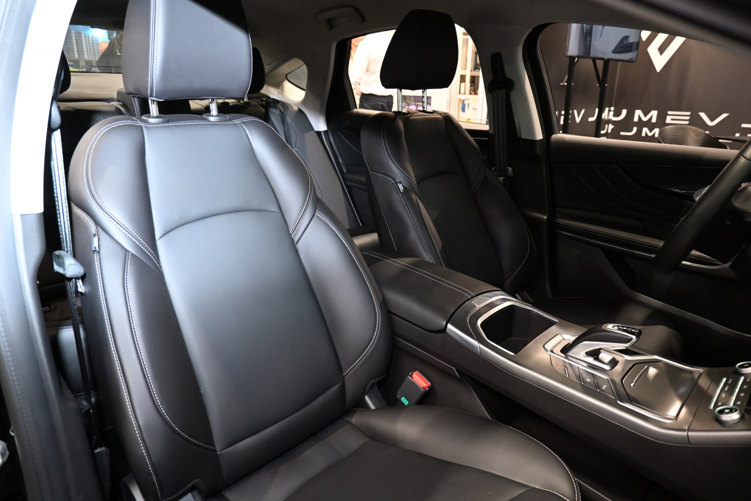 Black leather front seats with detailed stitching and modern center console