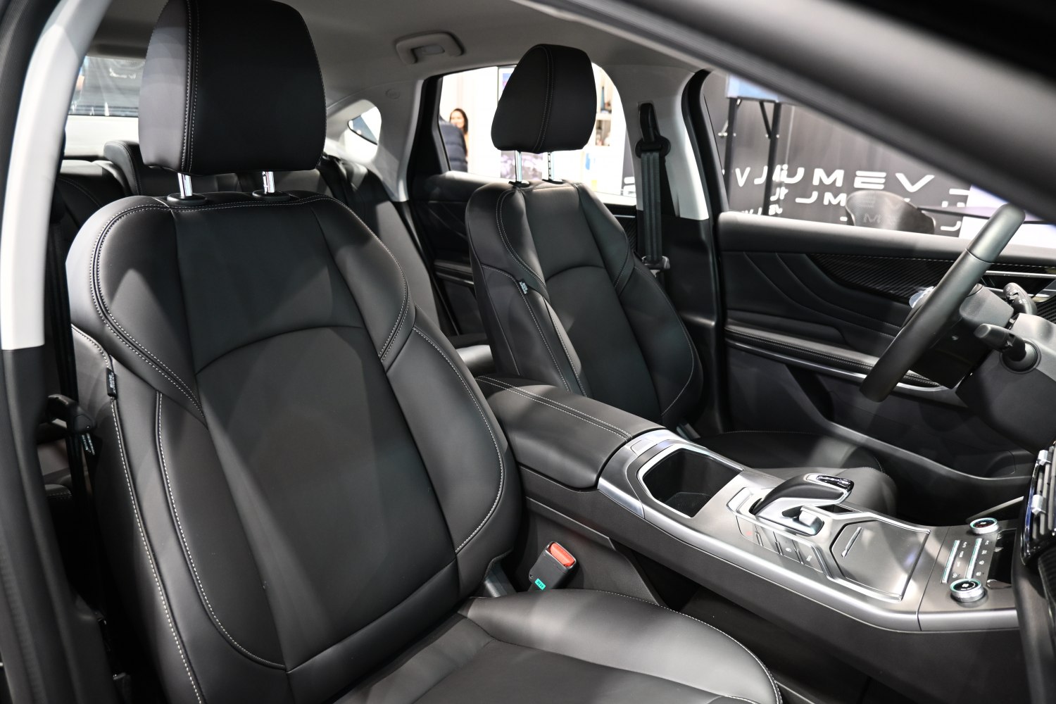 Black leather seats and modern center console in luxury vehicle interior