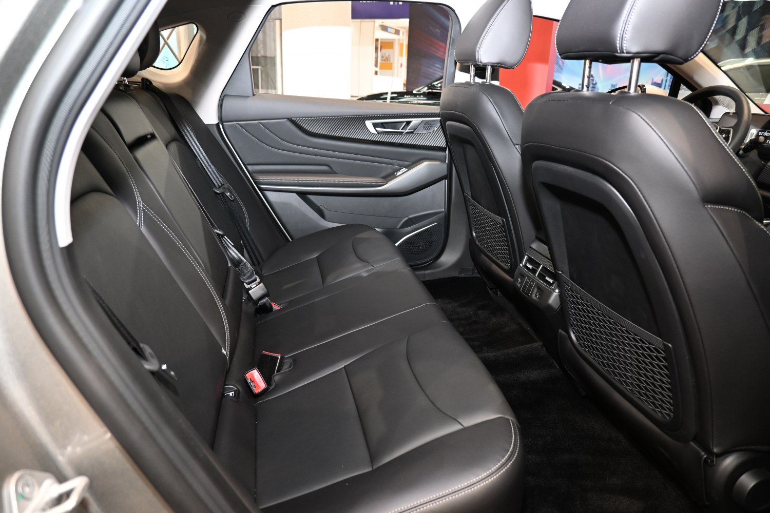 Spacious rear leather seats with detailed door panel and front seat backs