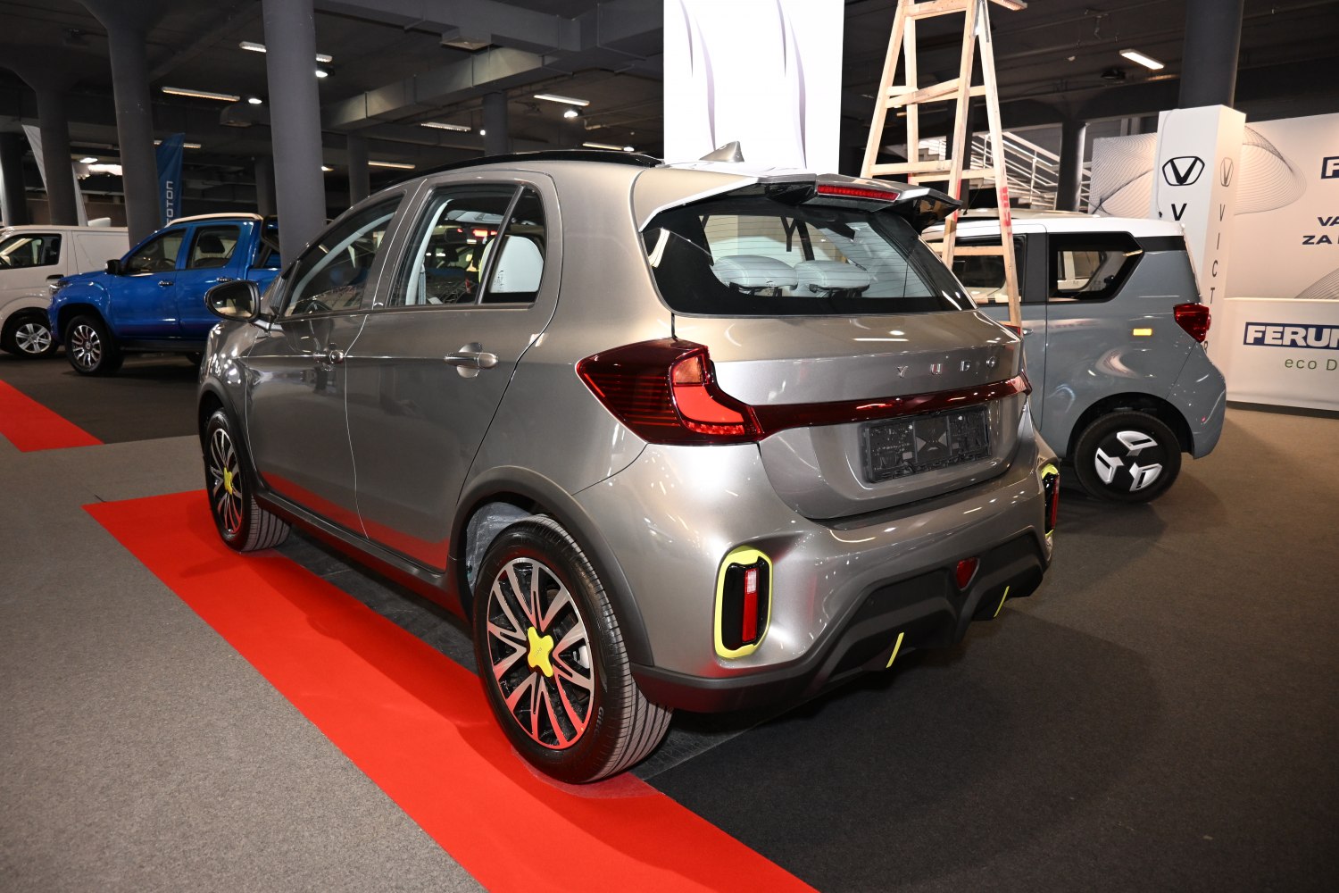 Rear view of modern compact hatchback with LED taillights and sporty alloy wheels.