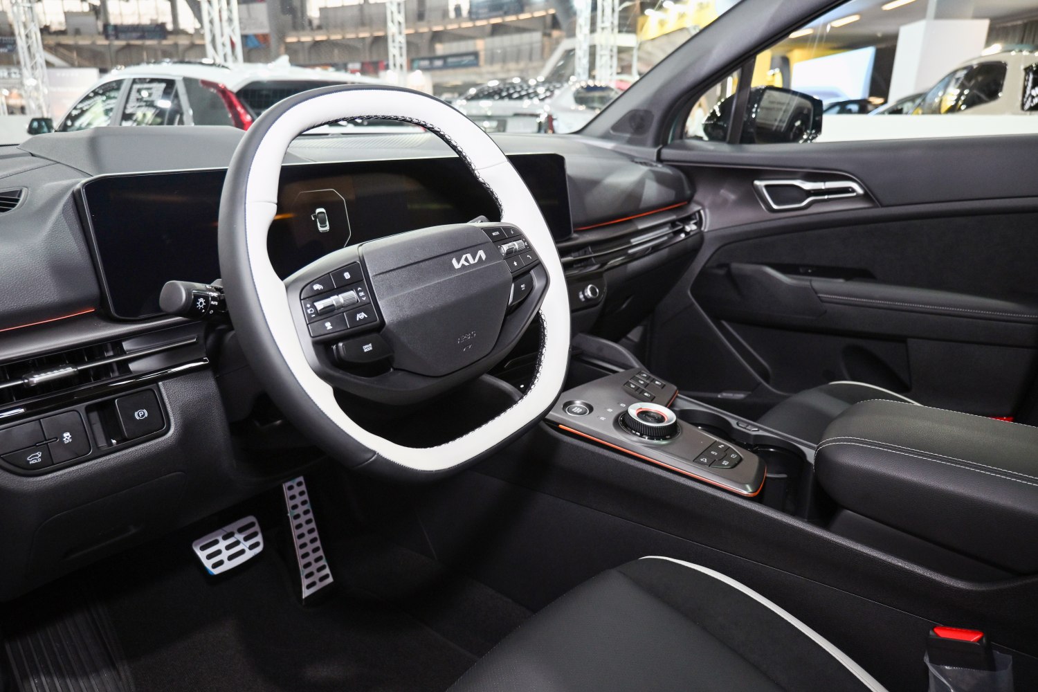 Digital dashboard and multifunction steering wheel in car interior.