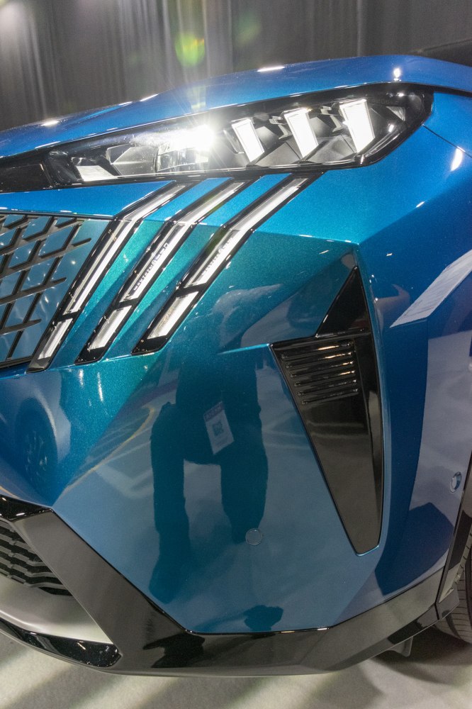 Close-up of LED headlights and chrome grille components on modern front fascia