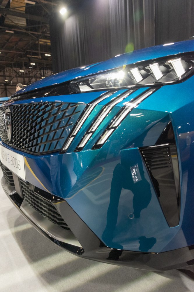 Close-up of front grille and LED headlights with vertical light accents
