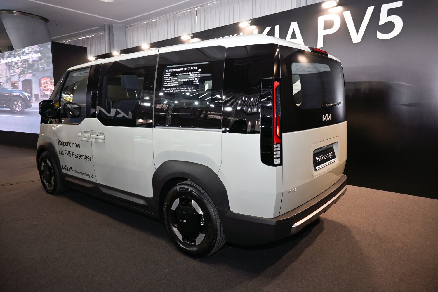 Rear-side view of futuristic minivan with sliding door