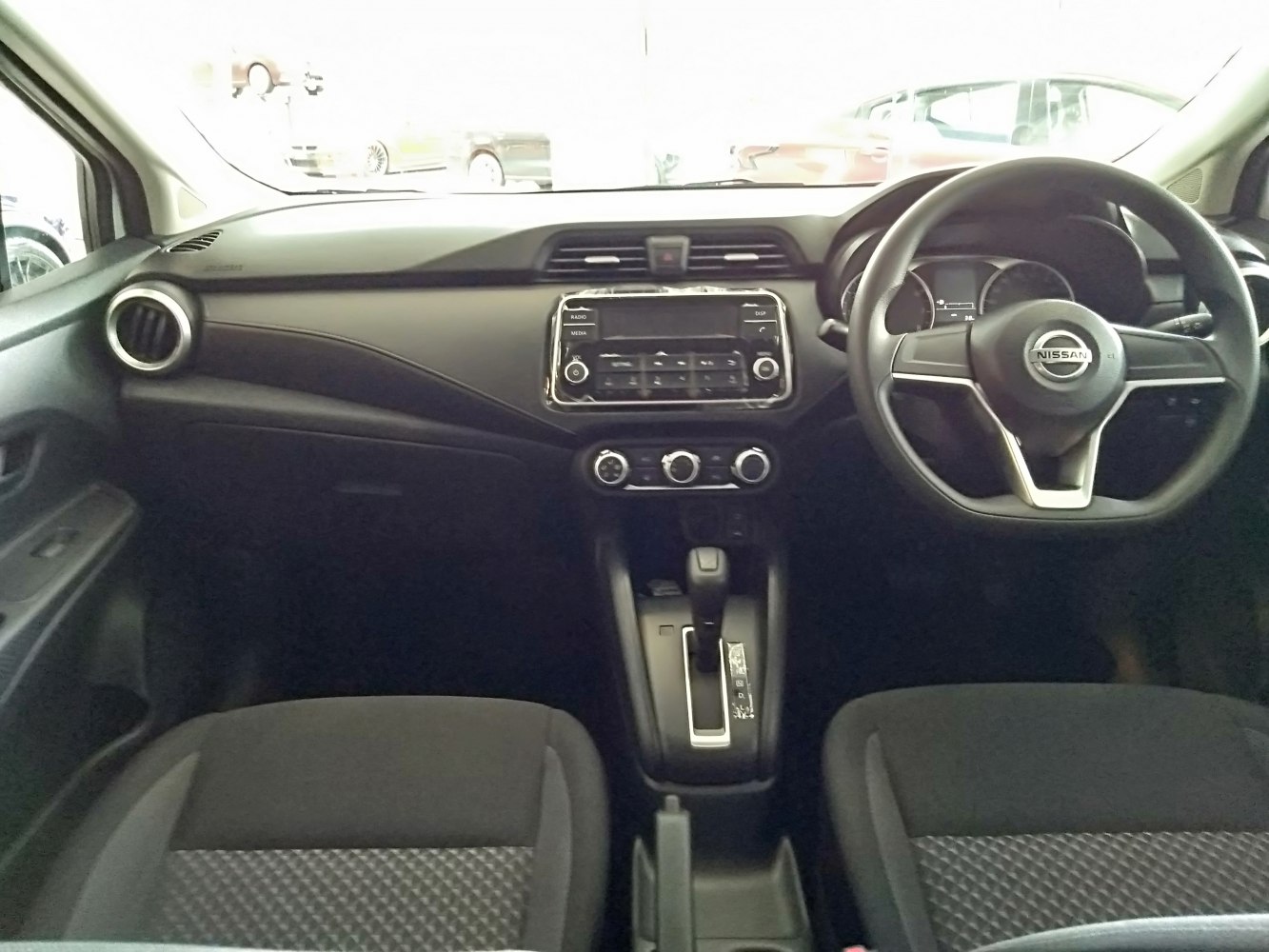 Dashboard, steering wheel, and central control panel of a car interior.