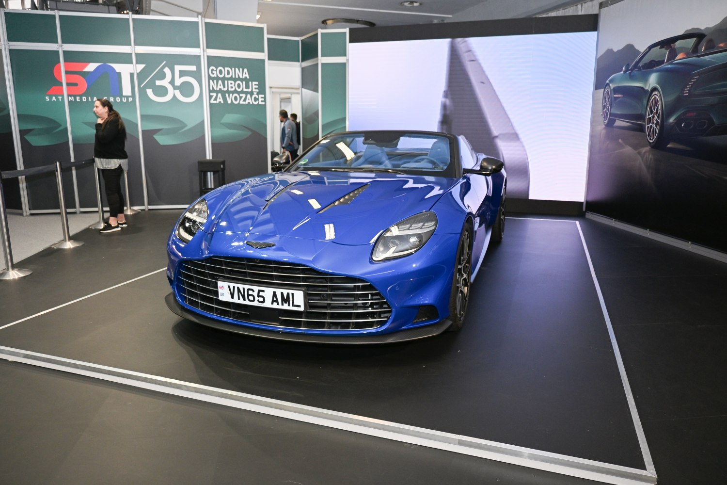 Blue convertible sports car with aggressive front grille and sleek aerodynamic lines