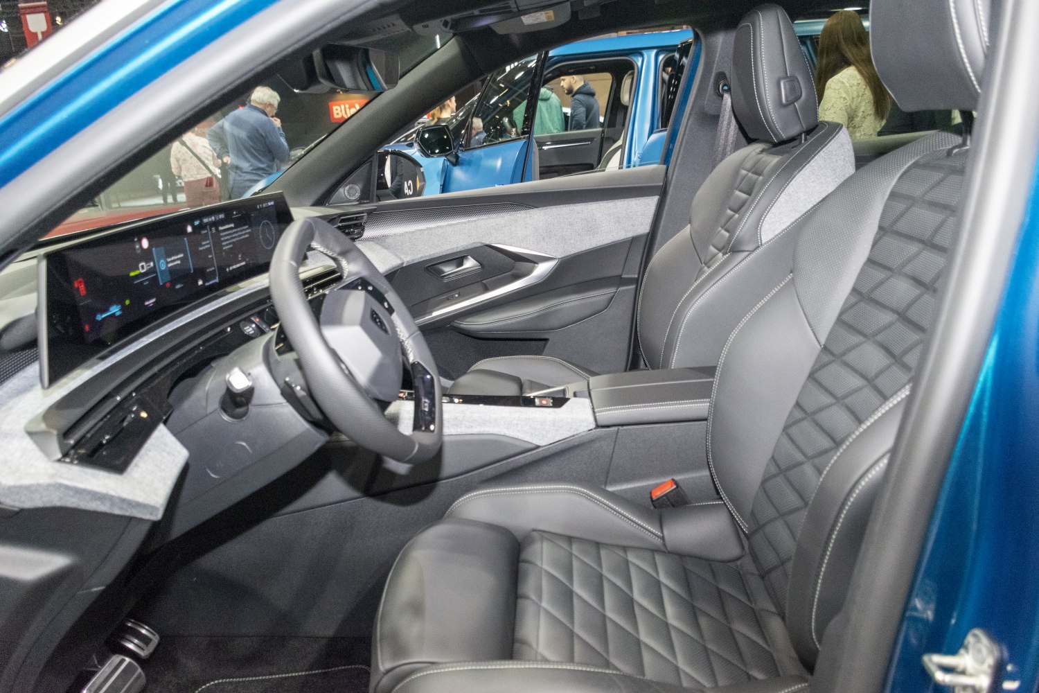 Digital dashboard and quilted leather seats in a car interior