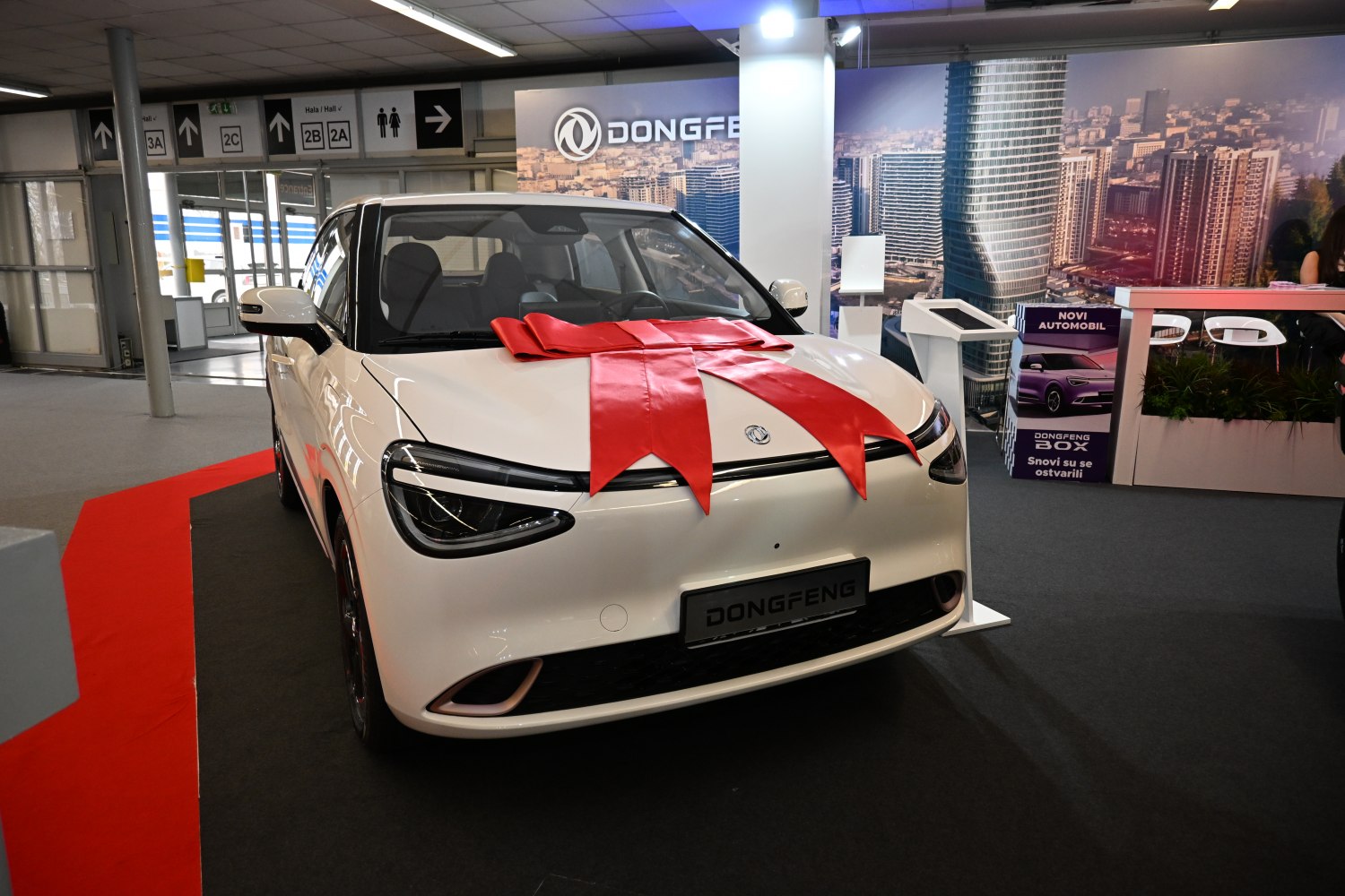 Compact electric vehicle with sleek front and LED headlights