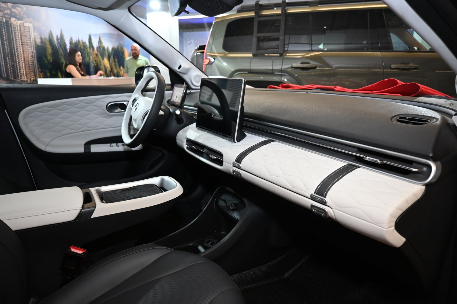 Modern car interior with digital dashboard and quilted white panels