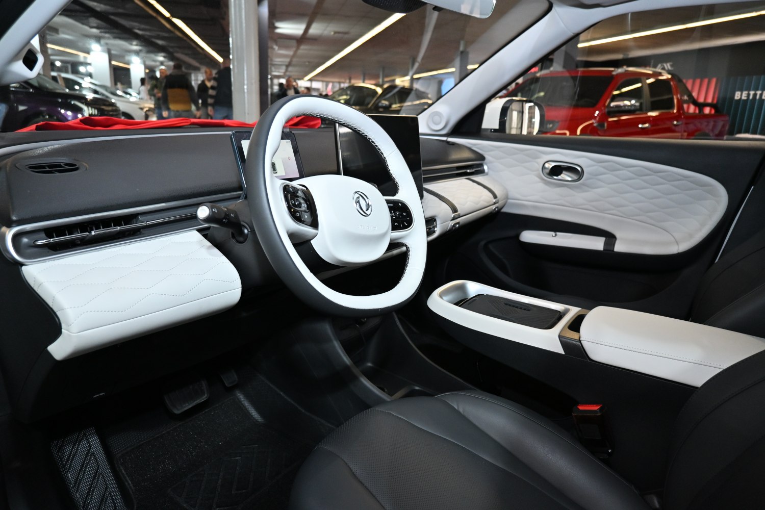 Modern steering wheel and quilted dashboard with door panel
