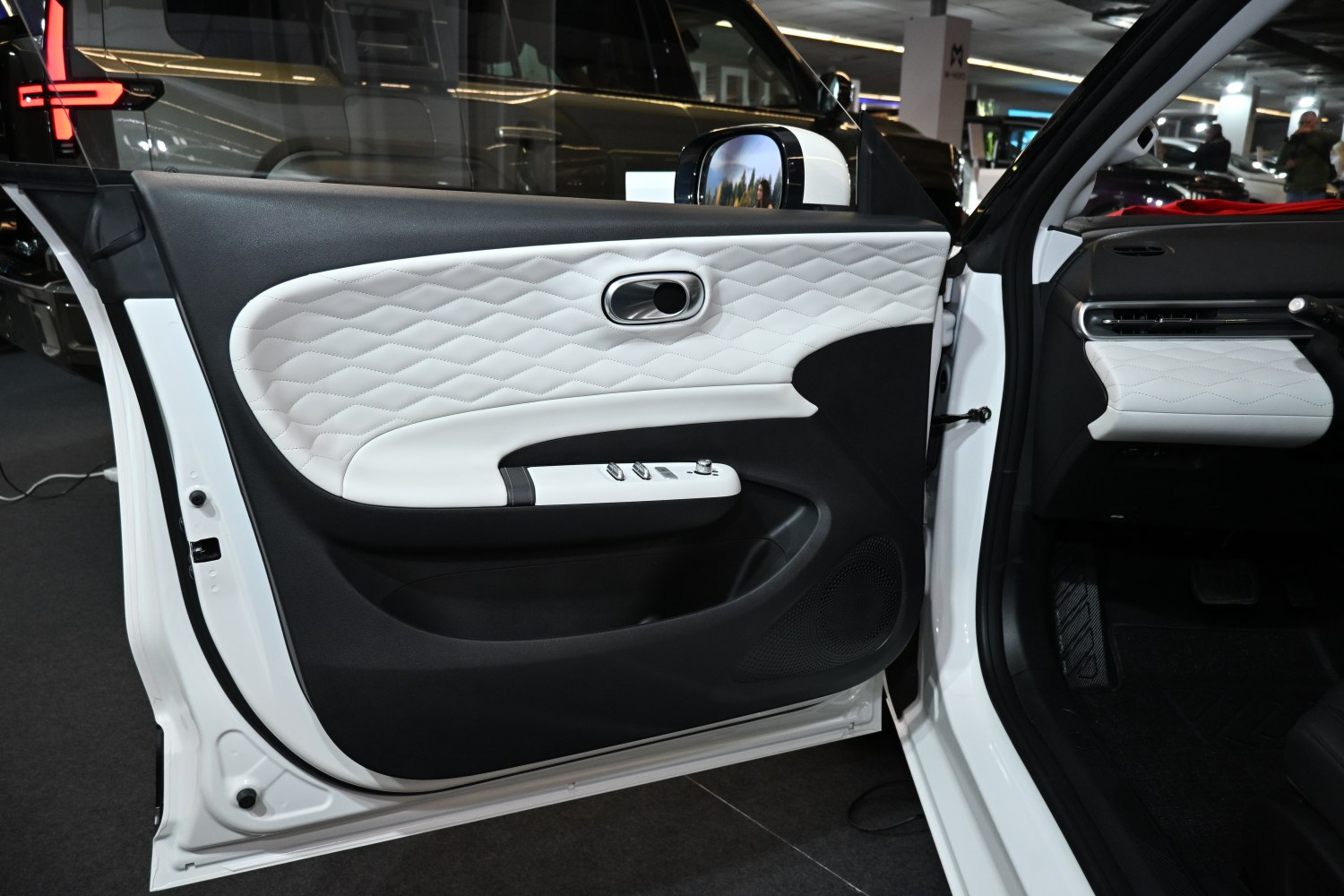 Quilted two-tone white and black interior door panel with controls