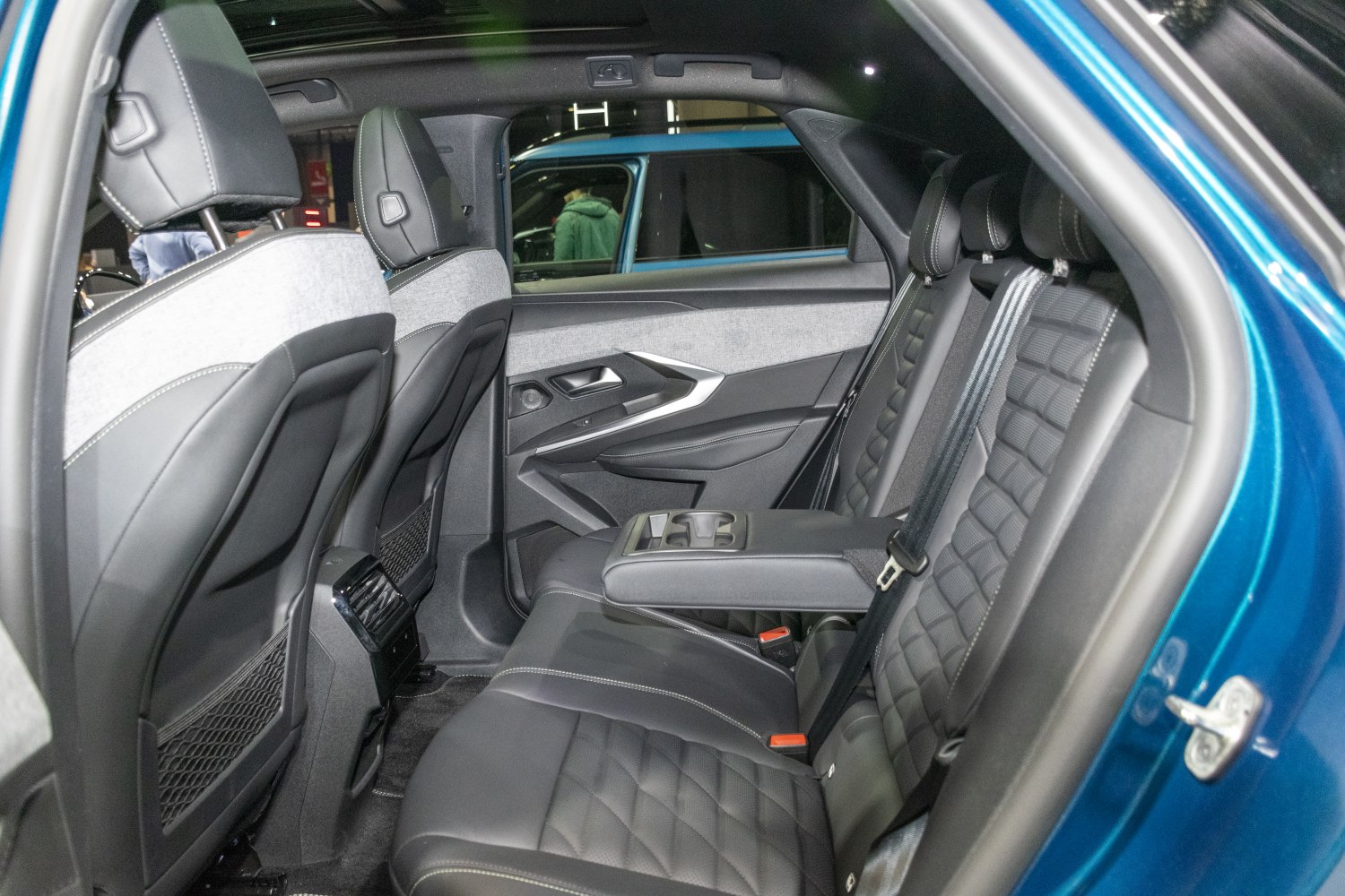 Rear seating interior with premium upholstery and fold-down armrest with cup holders
