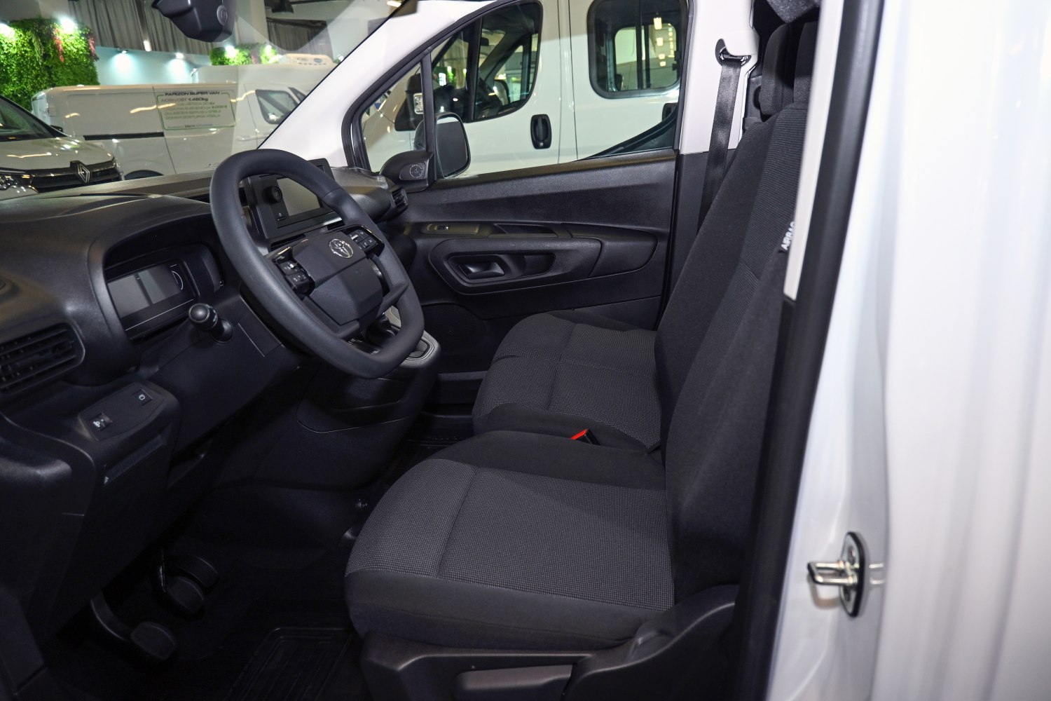 Front cabin with steering wheel and fabric seats