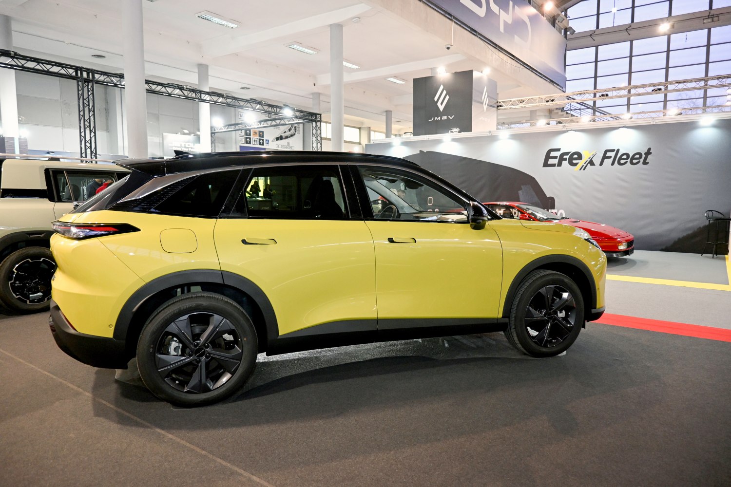 Side profile of a modern two-tone yellow and black SUV with black alloy wheels